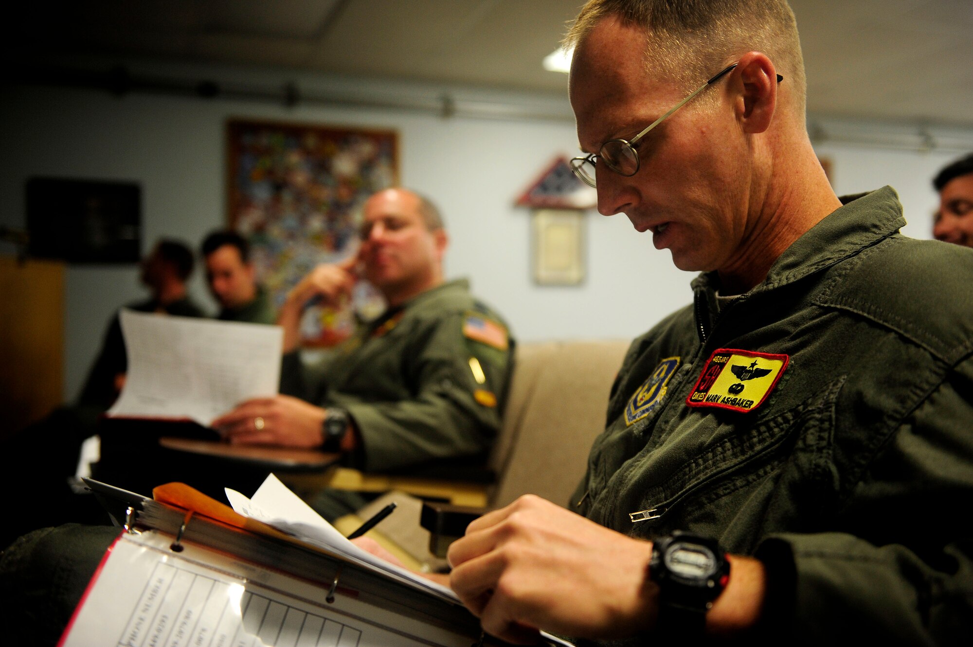 JOINT BASE PEARL HARBOR HICKAM, HAWAII (July 10, 2010) U.S. Air Force Lt. Col. Marv Ashbaker, assigned to the 465th Air Refueling Squadron, Tinker Air Force Base, Okla., looks over notes during a crew briefing for an air refueling mission in support of exercise Rim of the Pacific (RIMPAC) at Hickam Air Force Base, Hawaii, on July 10, 2010. RIMPAC is a biennial, multinational exercise designed to strengthen regional partnerships and improve interoperability. RIMPAC includes more than 14 nations 32 ships, five submarines, more than 170 aircraft and more than 20,000 Soldiers, Sailors, Marines and Airmen. (U.S. Air Force photo by Staff Sgt. Kamaile O. Long/Released)