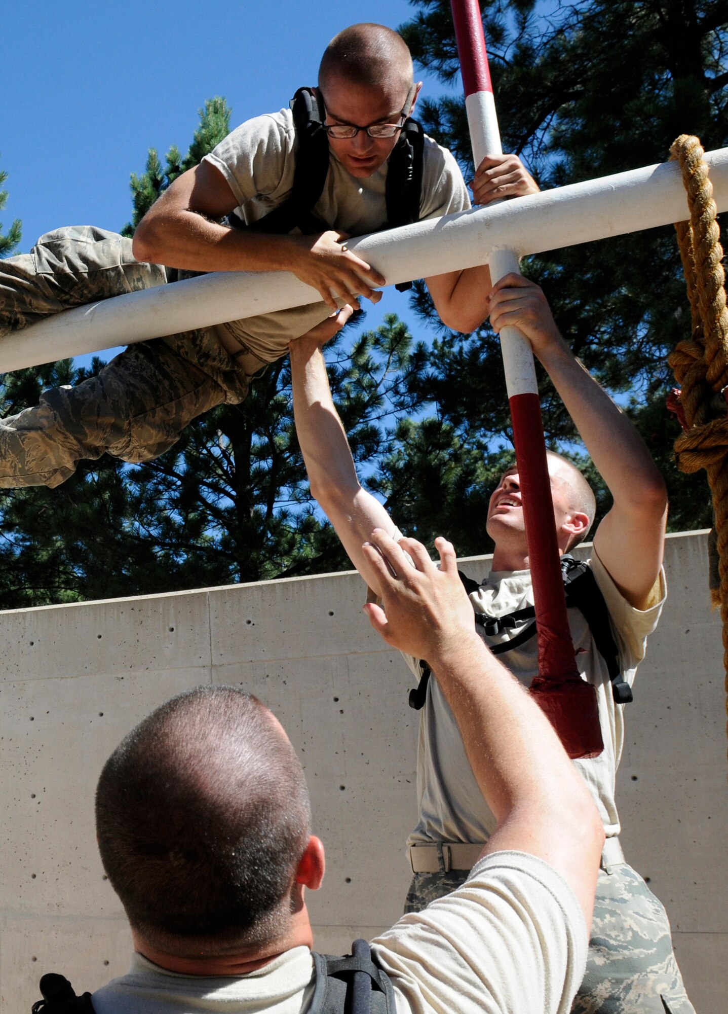 Basic Cadet Matthew Bettis gets a helping hand from a teammate as he makes his way through an obstacle at the Leadership Reaction Course in Jacks Valley training at the Air Force Academy July 16, 2010. The Leadership Reaction Course teaches basic cadets group and individual problem solving and effective leadership by having them work through 15 obstacles of varying difficulty. (U.S. Air Force photo/J. Rachel Spencer)