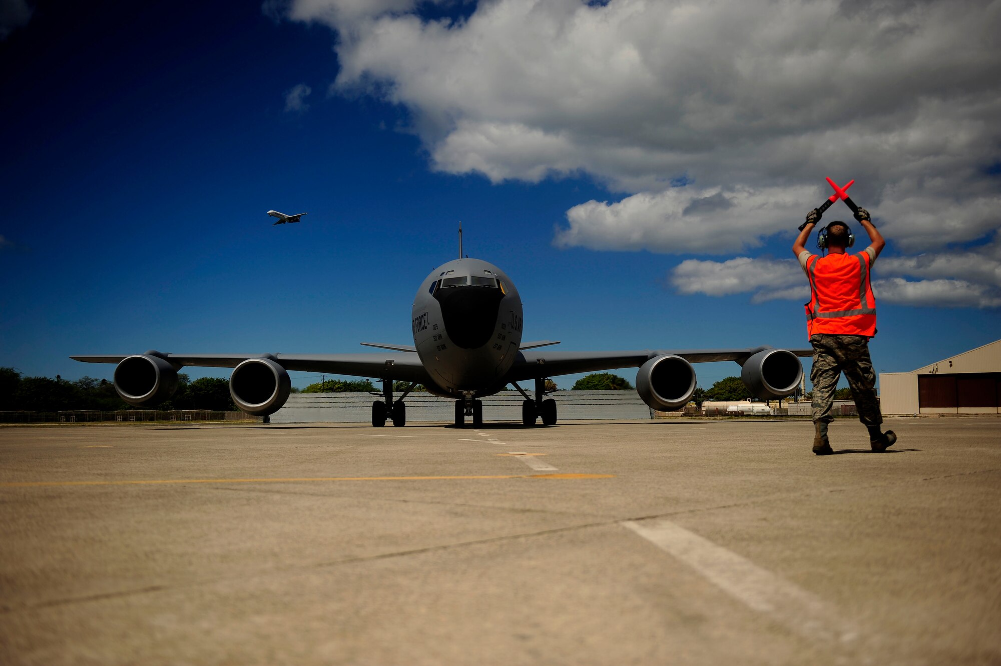 HICKAM AFB, HAWAII (July 15, 2010) U.S. Air Force Tech. Sgt. Timothy Milliken, crew chief, assigned to the 507th Aircraft Maintenance Squadron, Tinker Air Force Base, Okla., marshalls in a KC-135 Stratotanker from the 465th Air Refueling Squadro, Tinker AFB, Okla., after a refueling mission in support of exercise Rim of the Pacific (RIMPAC), at Hickam Air Force Base, Hawaii, on July 15, 2010.  RIMPAC is a biennial, multinational exercise designed to strengthen regional partnerships and improve interoperability.  RIMPAC includes more than 14 nations 32 ships, five submarines, more than 170 aircraft and more than 20,000 Soldiers, Sailors, Marines and Airmen.  (U.S. Air Force photo by Staff Sgt. Kamaile O. Long/Released)


