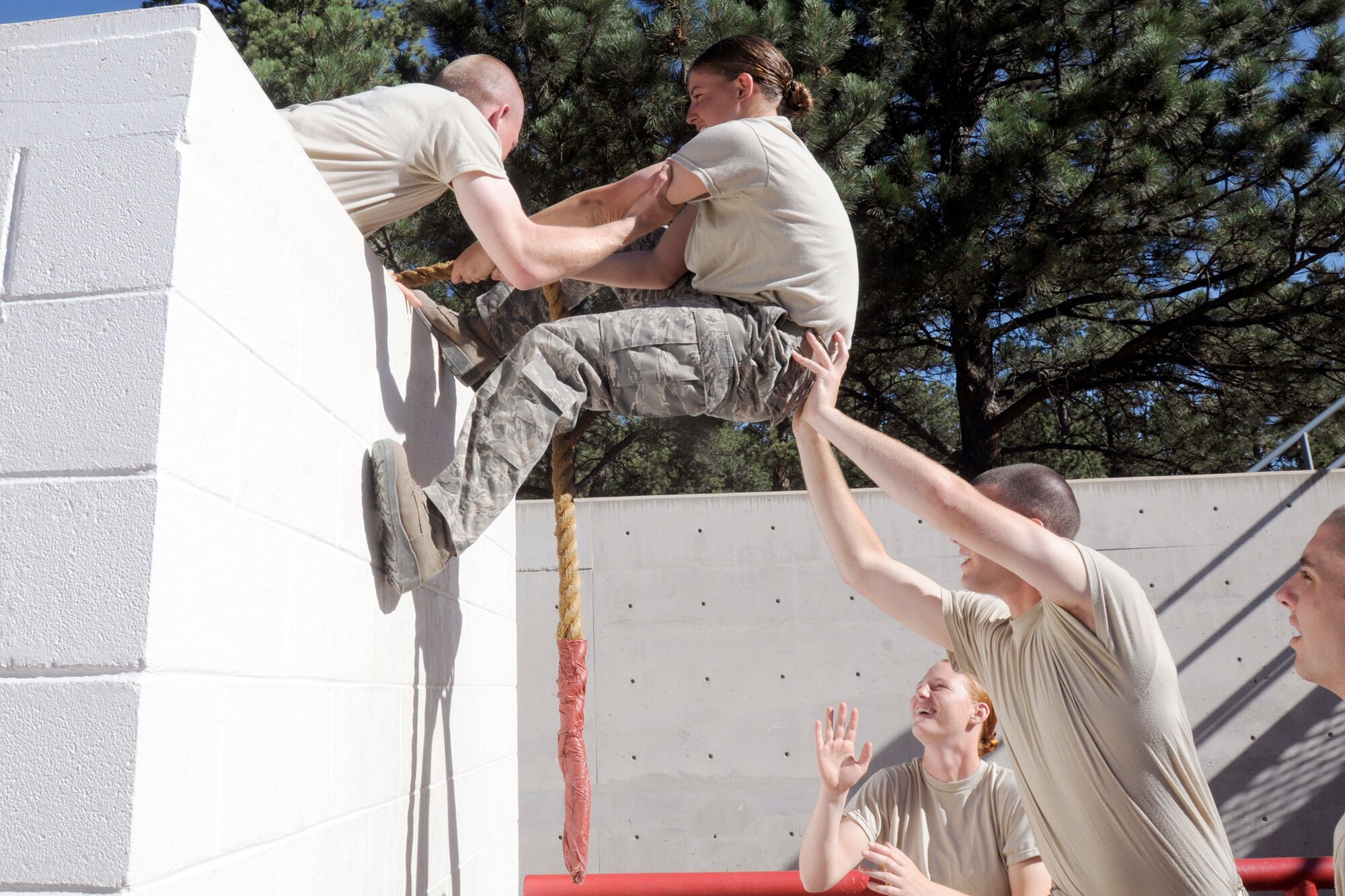 Basic Cadet Ory Schuman is helped up by teammate Alyssa Van during the leadership reaction course at the U.S. Air Force Academy, Colo., July 16, 2010. The cadets learned essential problem solving and leadership techniques from the course. (U.S. Air Force photo/J. Rachel Spencer)
