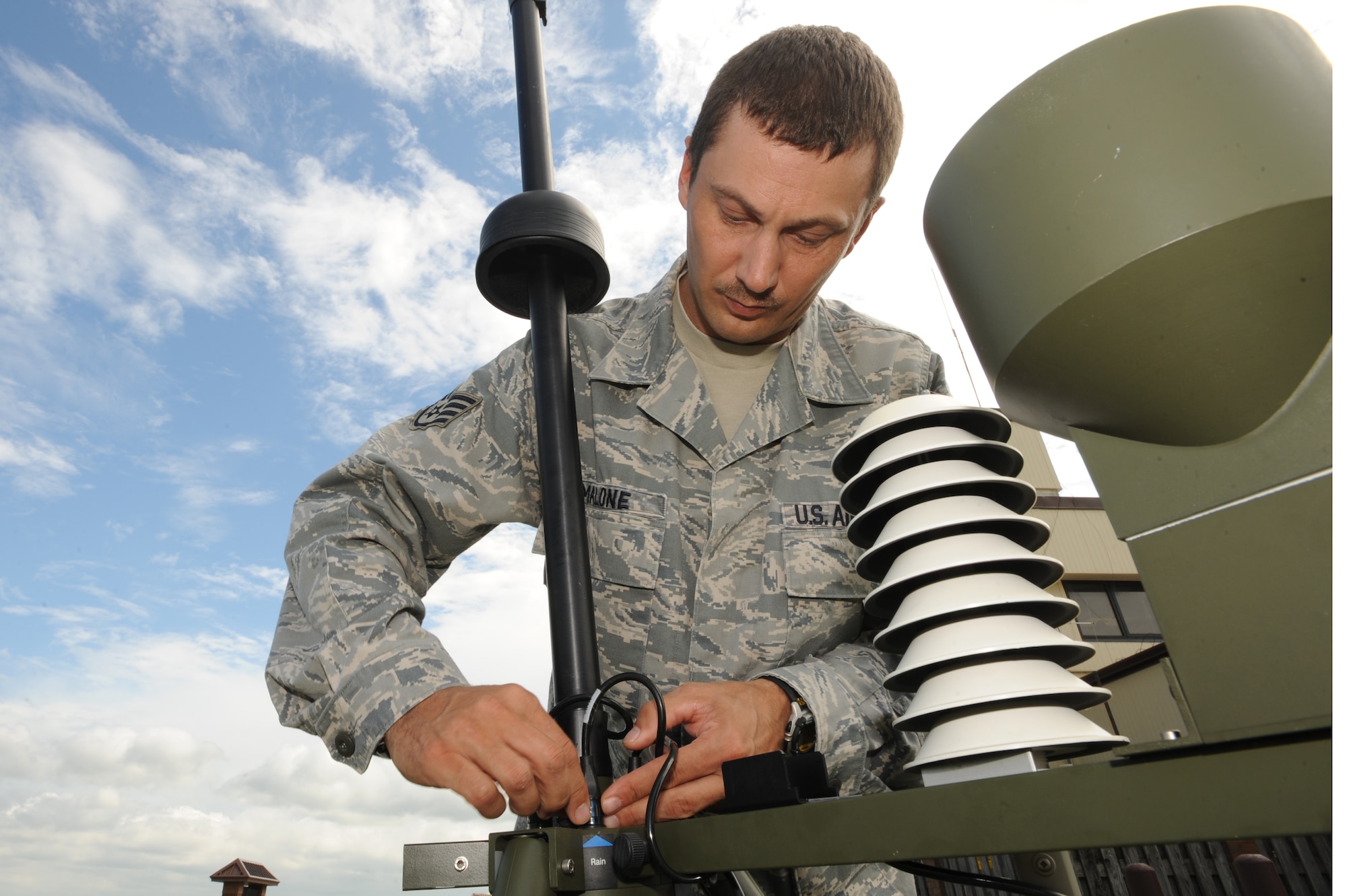 WHITEMAN AIR FORCE BASE, Mo. - Staff Sgt. Charles Malone, 509th Operation Support Squadron weather forecaster, readies a surveying instrument as part of the Tactical Meteorological System Observing station, July 6. The TMOS systems can be set up and sending data in 15 minutes. (U.S. Air Force photo by Senior Airman Carlin Leslie)(Released)
