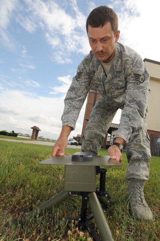 WHITEMAN AIR FORCE BASE, Mo. - Staff Sgt. Charles Malone, 509th Operation Support Squadron weather forecaster, connects the Tactical Meteorological System Observing Station's main antenna to test operation readiness, July 6. The TMOS is a solar-powered mobile weather center that transmits readings to a laptop. (U.S. Air Force photo by Senior Airman Carlin Leslie)(Released)
