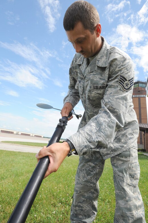 WHITEMAN AIR FORCE BASE, Mo. - Staff Sgt. Charles Malone, 509th Operation Support Squadron weather forecaster, prepares the Tactical Meteorological System Observing station to test its operational readiness, July 6. The TMOS is a solar-powered mobile weather center that transmits readings to a laptop. (U.S. Air Force photo by Senior Airman Carlin Leslie)(Released)

