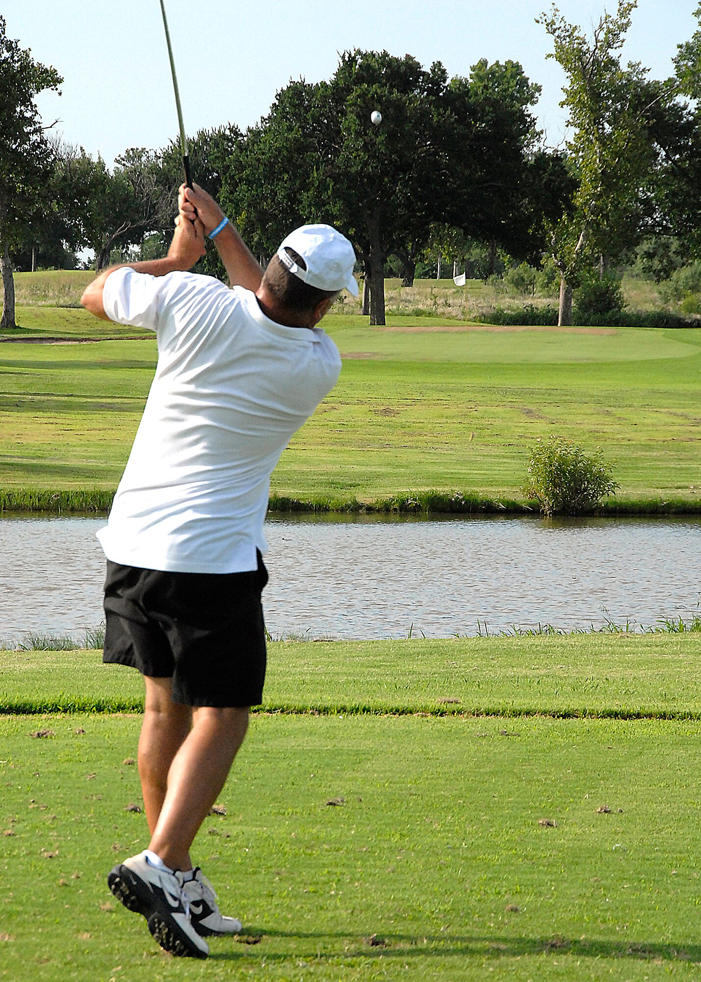 Jim Winters tees off on Hole No. 2 July 15 at Wind Creek Golf Course on Sheppard Air Force Base. Mr. Winters, an Air Force retiree and simulator instructor at the 80th Flying Training Wing, plays the course about two-to-three times per week. (U.S. Air Force photo/Harry Tonemah)