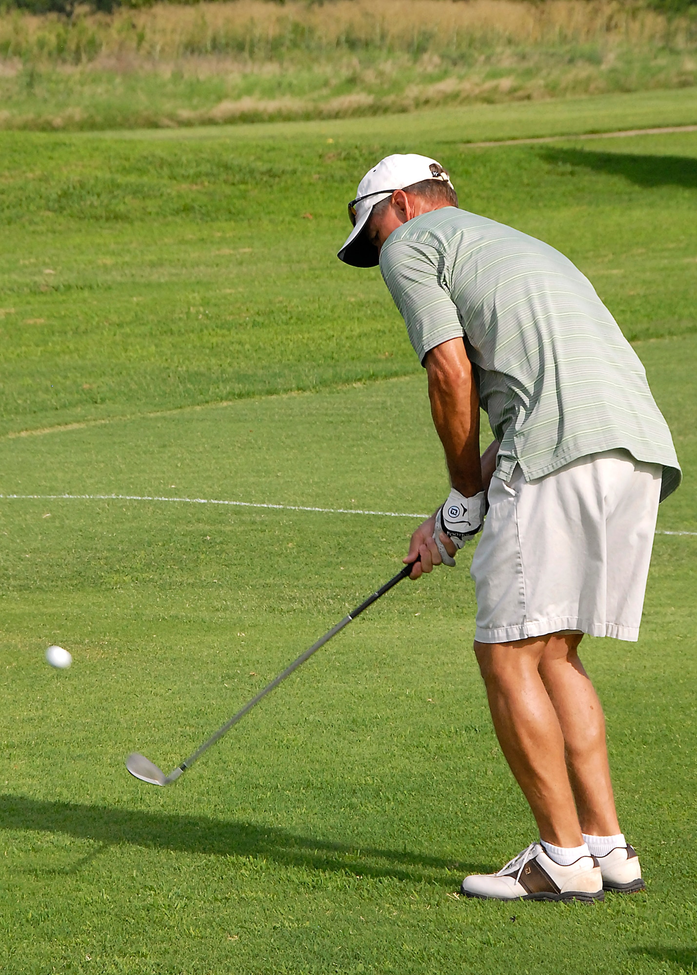 Dale Vis, an Air Force retiree and simulator instructor at the 80th Flying Training Wings, chips onto the green July 15 at Wind Creek Golf Course on Sheppard Air Force Base. Mr. Vis said he enjoys playing the course because of its convenience as well as its variety. (U.S. Air Force photo/Harry Tonemah)