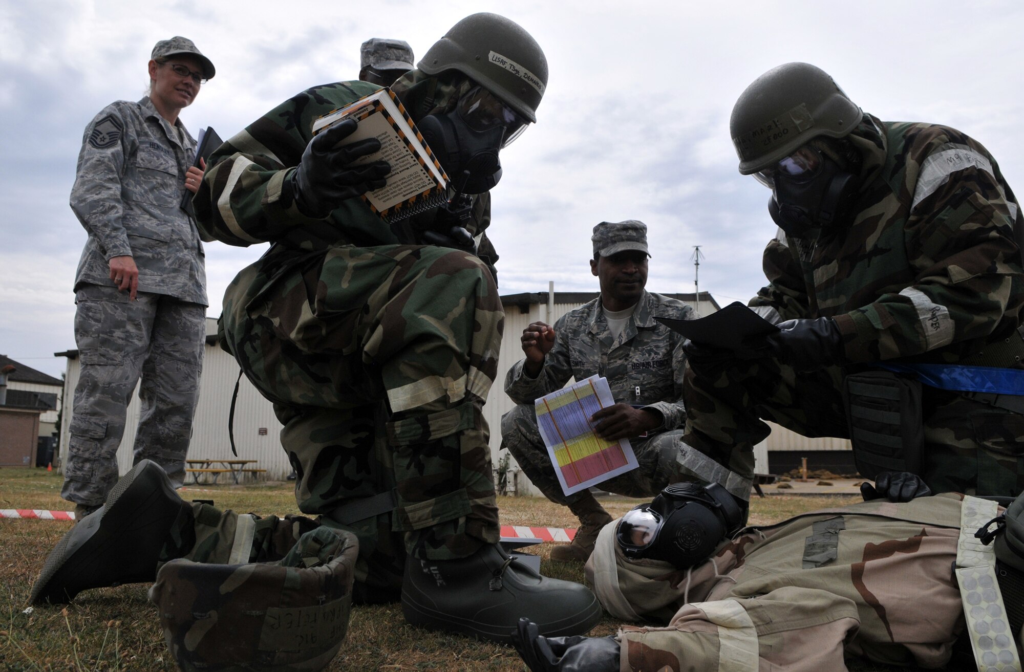 RAF MILDENHALL, England -- Several 100th Air Refueling Wing Exercise Evaluation Team members observe and evaluate the treatment of an Airman who suffered a simulated shrapnel wound during an exercise July 20.  (U.S. Air Force photo/Staff Sgt. Austin M. May)