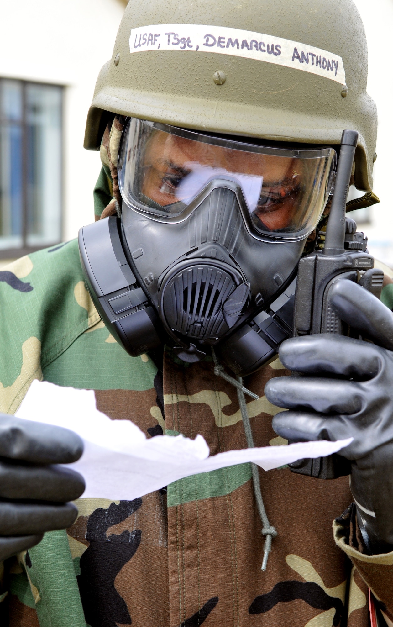 RAF MILDENHALL, England -- Tech. Sgt. Demarcus Anthony, 100th Logistics Readiness Squadron, calls in a post-attack report during an exercise July 20.  Sergeant Anthony was part of a team assigned to check the exterior of his building following a simulated attack during exercise Quick Bank 10-06.  (U.S. Air Force photo/Staff Sgt. Austin M. May)