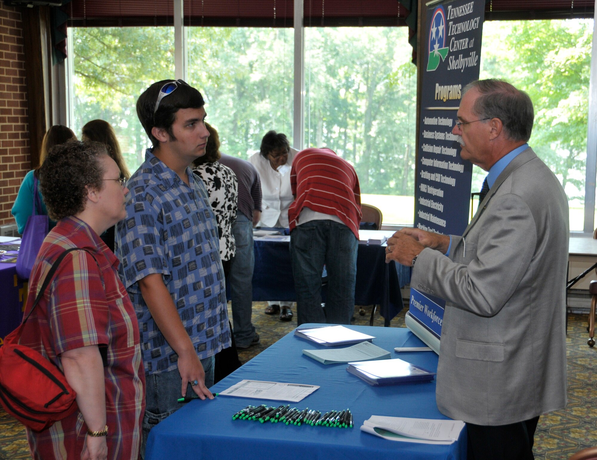 Many AEDC employees, including this family, visited with Ivan Jones, Director of Tennessee Technology Center in Shelbyville, Tennessee to see what programs and opportunities were available during the AEDC Education Fair held July 15, 2010.