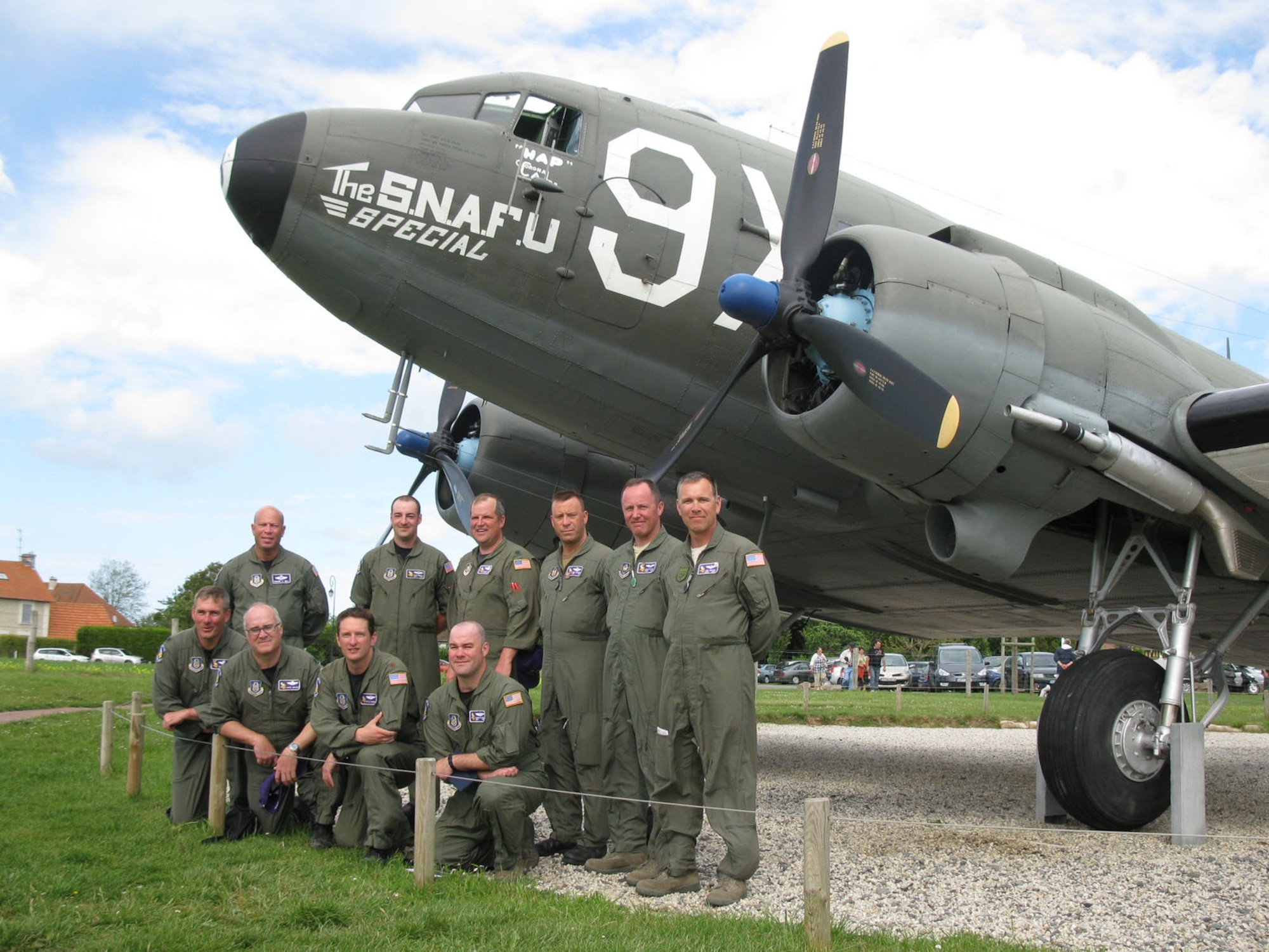 Members of the 96th Airlift Squadron pose in front of a C-47 June 6. The aircraft was once part of the 440th Troup Carrier Group; the group the 96th was part of. (Air Force Photo/Lt. Col. Howard Bell)