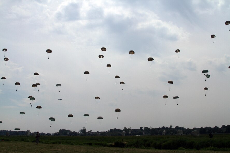 Flying Viking C-130s perfomr airdrops over Big Mike Drop Zone, Normandy France. (Air Force Photo/Lt. Col. Howard Bell)