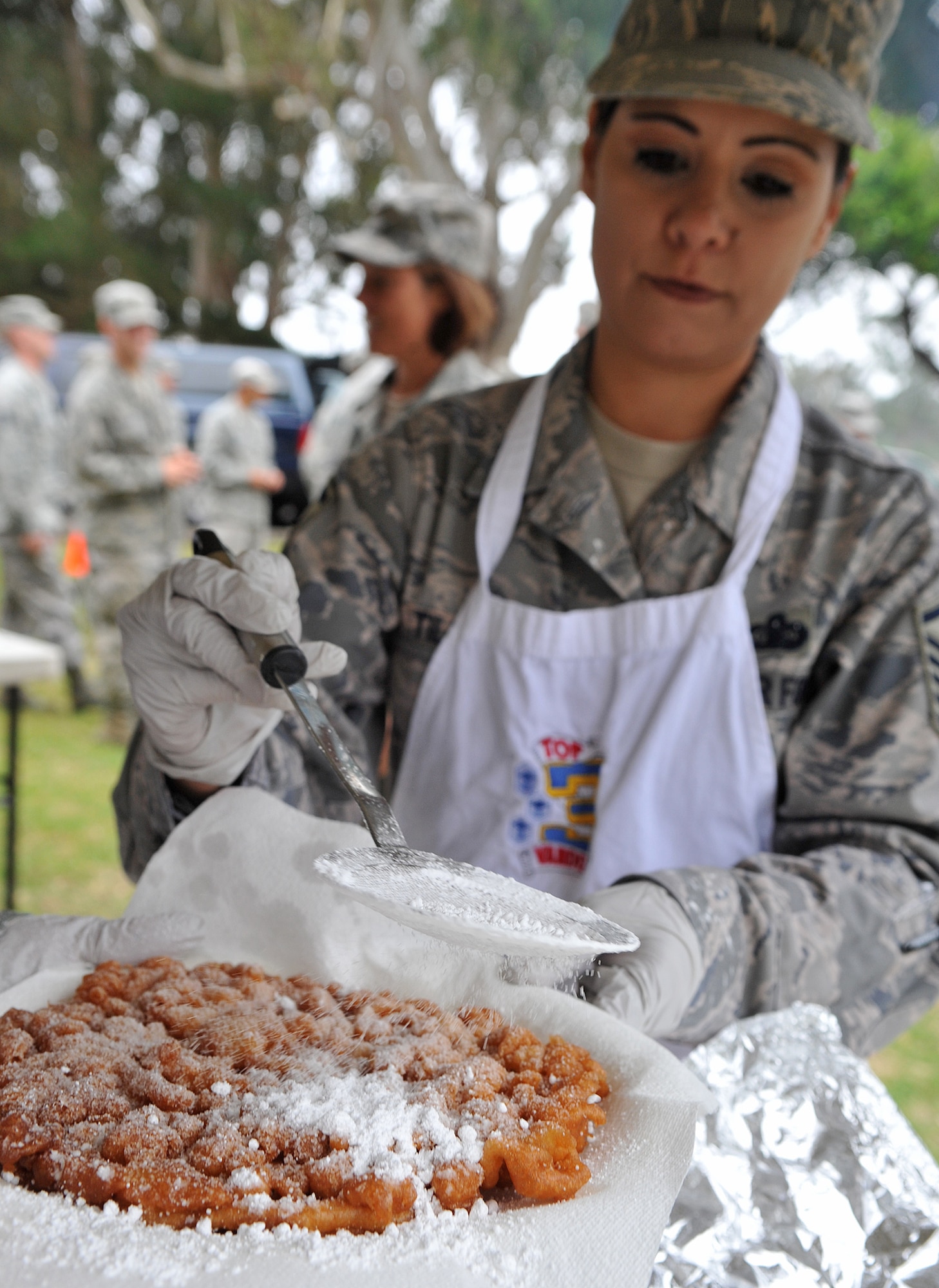 VANDENBERG AIR FORCE BASE, Calif. -- Using extreme finesse, Master Sgt. Christiana Tilton, sprinkles powdered sugar on top of a freshly made funnel cake during the Airmen Appreciation Barbecue here Friday, July 16, 2010.(U.S. Air Force photo/Senior Airman Andrew Lee)
