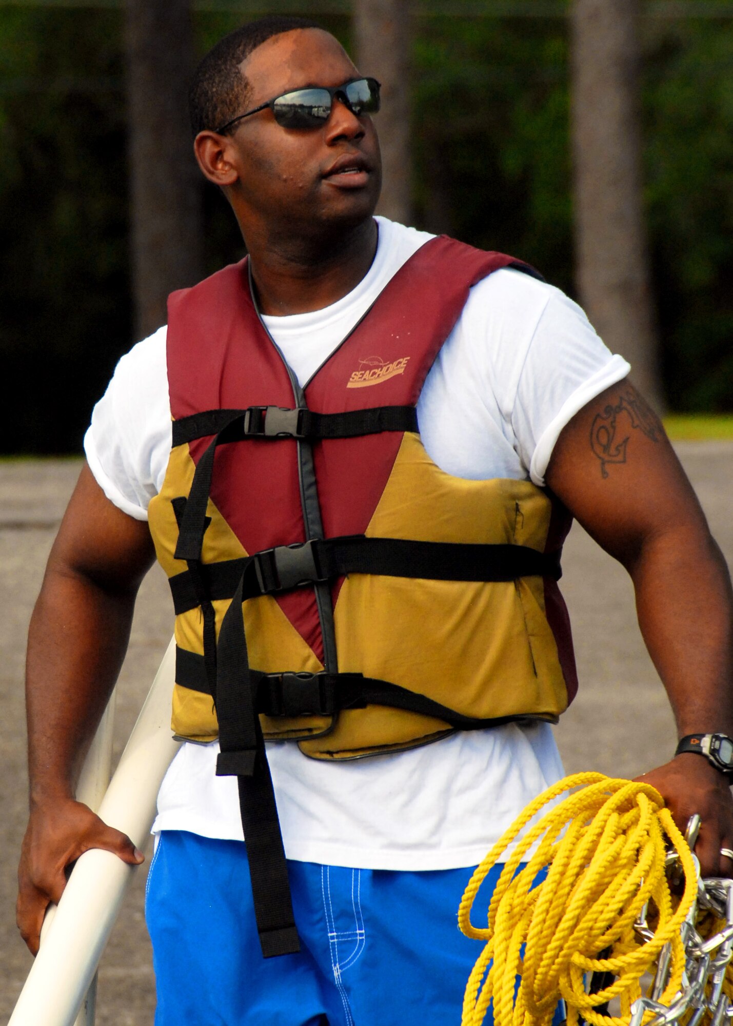 A volunteer carries equipment used to install an oil boom to the boat at Eglin Air Force Base, Fla., July 14.    Boom is an oil containment device used to trap oil in the water so it can be collected before reaching the shore.  Approximately 2,000 feet of booms have been installed around Eglin waterways.  (U.S. Air Force photo/Samuel King Jr.)