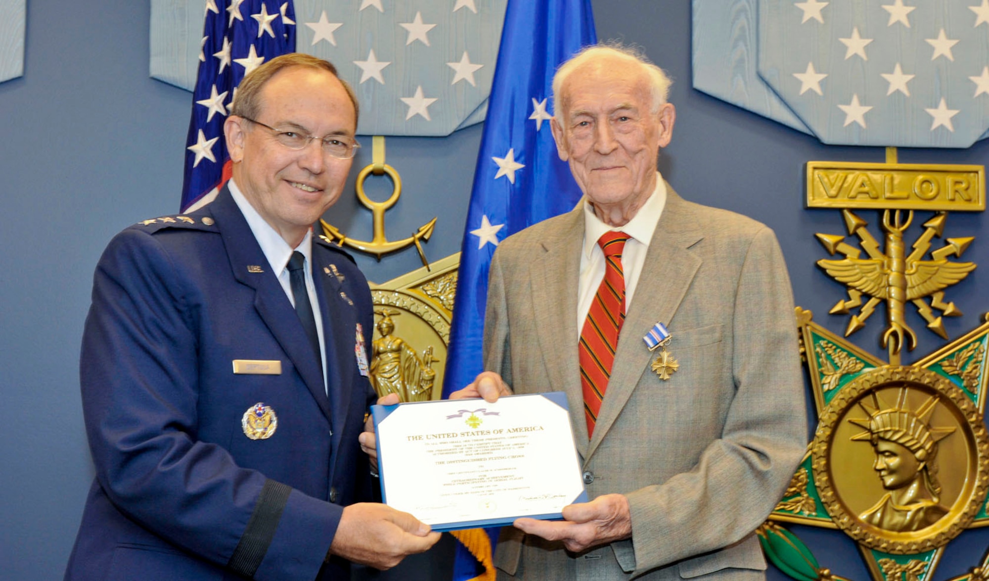 Retired Col. Claude M. Schonberger poses with Lt. Gen. David A. Deptula July 19, 2010, in the Pentagon's Hall of Heroes after being presented with the Distinguished Flying Cross. General Deptula is the deputy chief of staff for intelligence, surveillance and reconnaissance at Headquarters Air Force. (U.S. Air Force photo/Michael Pausic)