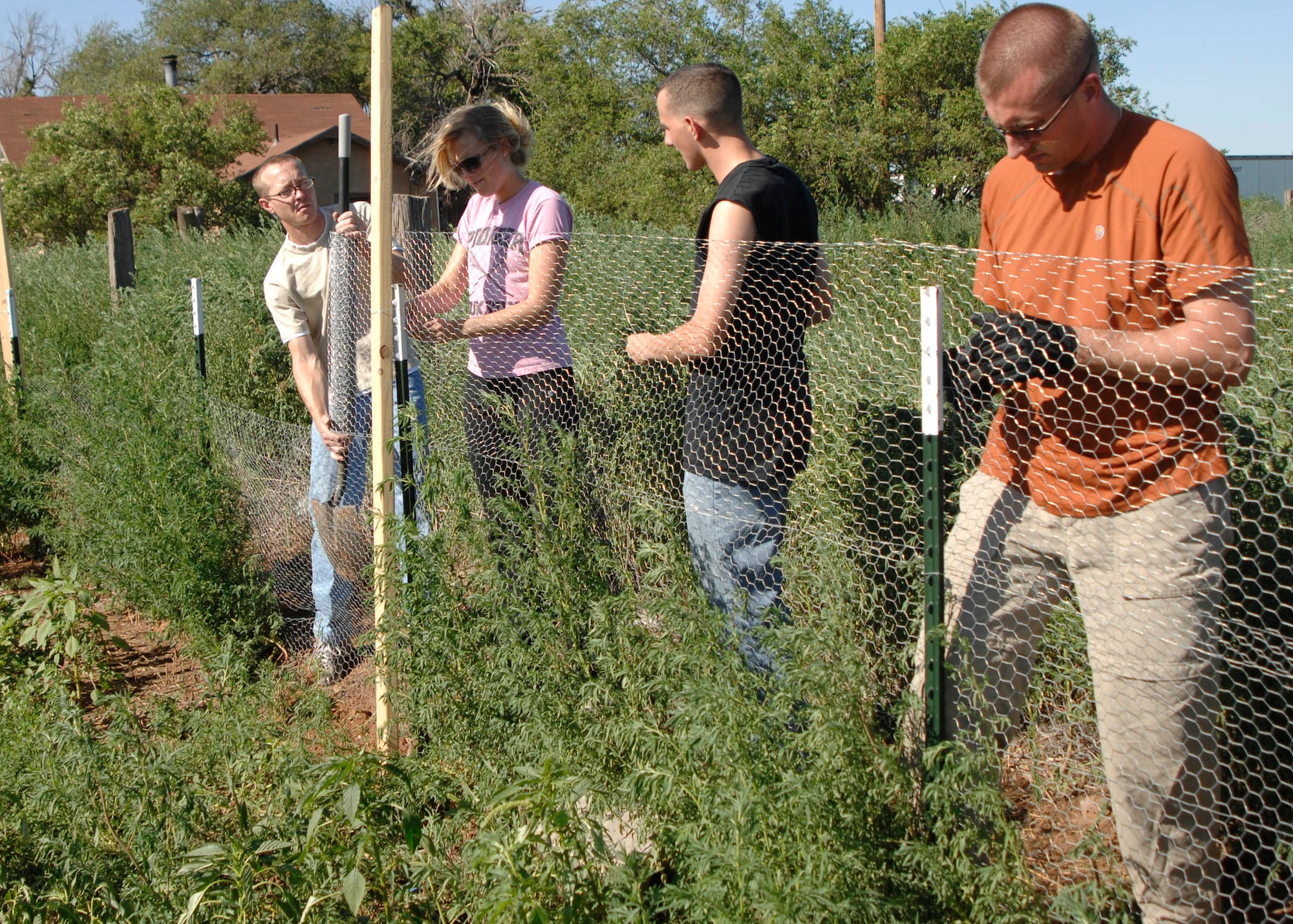 Airmen from the 33rd Special Operations Squadron at Cannon Air Force Base, N.M., build a chicken coop for Gabriel's Garden, a community project that provides fresh vegetables and eggs for the needy. The garden is the idea of Clovis, N.M., resident Lori Yanez, who named it after her deceased husband, Gabriel, who envisioned a garden that that would be shared with others. (U.S. Air Force photo by Greg Allen) (RELEASED)
