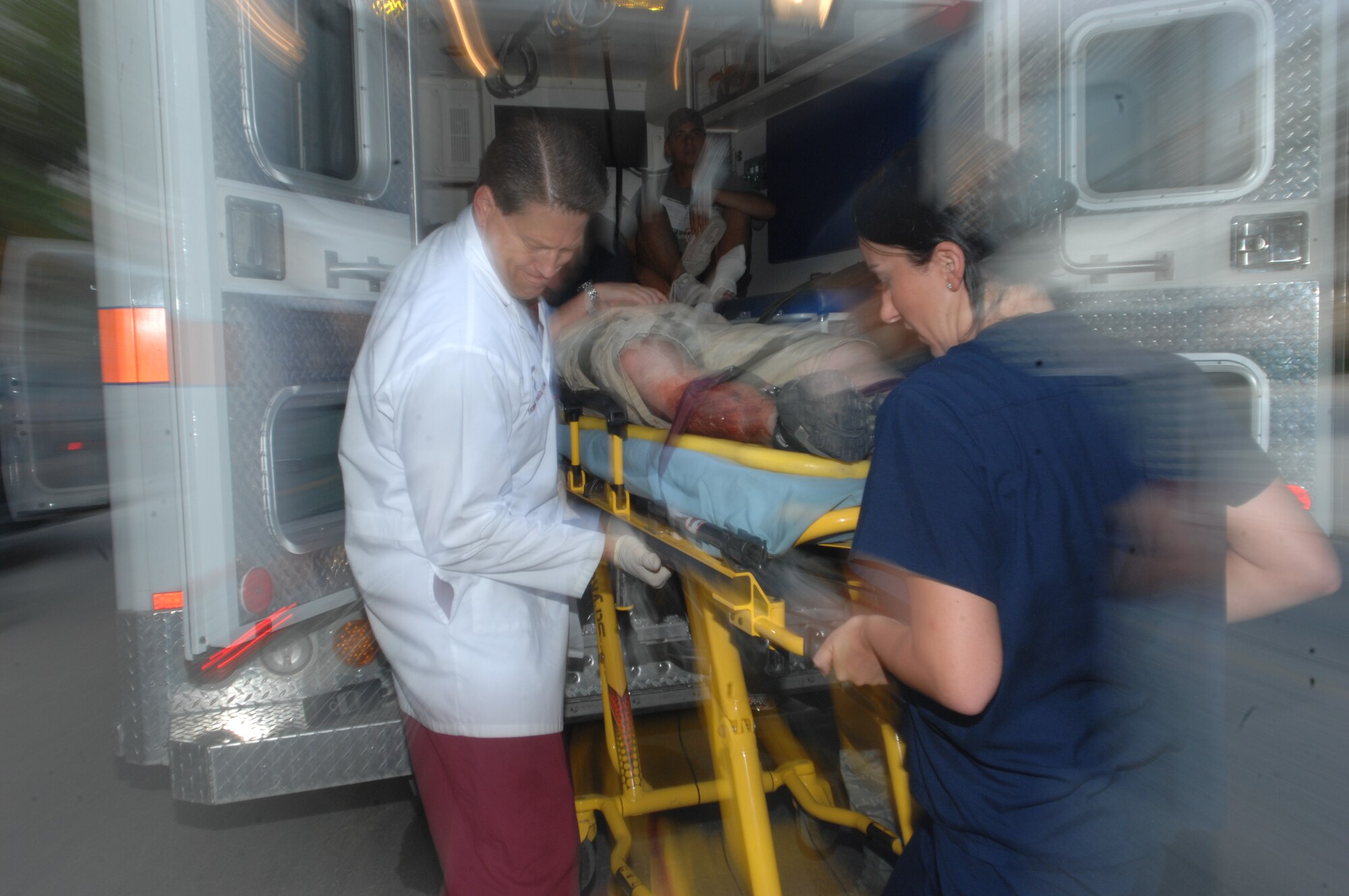 Lt. Col. Jeffry Larson and Senior Airman Courtney Turner, 39th Medical Operations Squadron, transfer a mock victim to an ambulance during a Major Accident Response Exercise, July 13, 2010 at Incirlik Air Base. The exercise tested the base’s ability to quickly respond to a major incident involving mass causalities to include accurate and timely accountability.  (U.S. Air Force Photo/Tech Sgt. Valda Wilson)