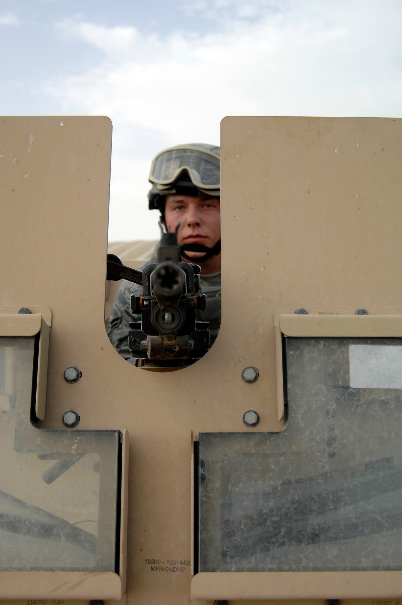 Airman 1st Class Jordan Silvertooth Dugas, 380th Expeditionary Security Forces Squadron, sits in the turret of a reconditioned Humvee, July 9, at an undisclosed location in Southwest Asia. The Humvee was of 13 vehicles the 380th Expeditionary Logistics Readiness Squadron Expeditionary Logistics Readiness Squadron delivered to the 380th ESFS. (U.S. Air Force Photo/Staff Sgt. Jeremy Larlee/released) 