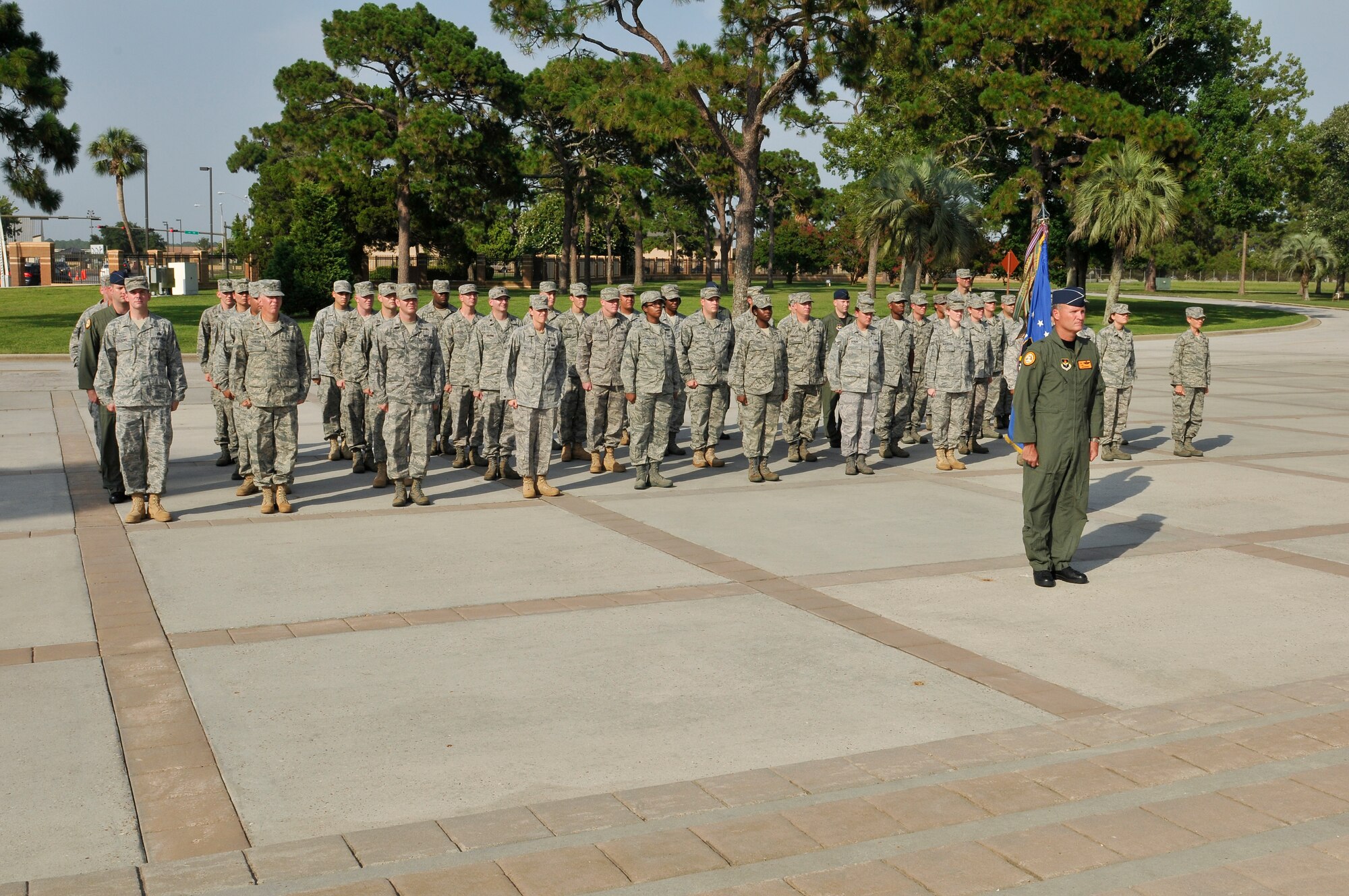 Members of the 325th Fighter Wing staff stand at attention during a retreat ceremony July 14. Brigadier Gen. James S. Browne, 325th FW commander, leads the formation. Retreat ceremonies will be held each month and be rotated among the squadrons. (U.S. Air Force photo/Lisa Norman)