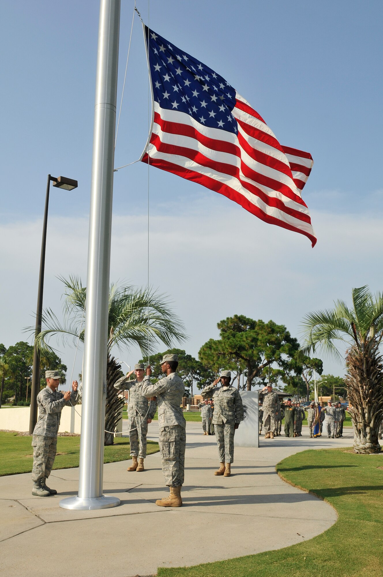 The 325th Fighter Wing honor guard lower the flag during a retreat ceremony July 14. Brigadier Gen. James S. Browne, 325th FW commander, leads the formation. Retreat ceremonies will be held each month and be rotated among the squadrons. (U.S. Air Force photo/Lisa Norman)