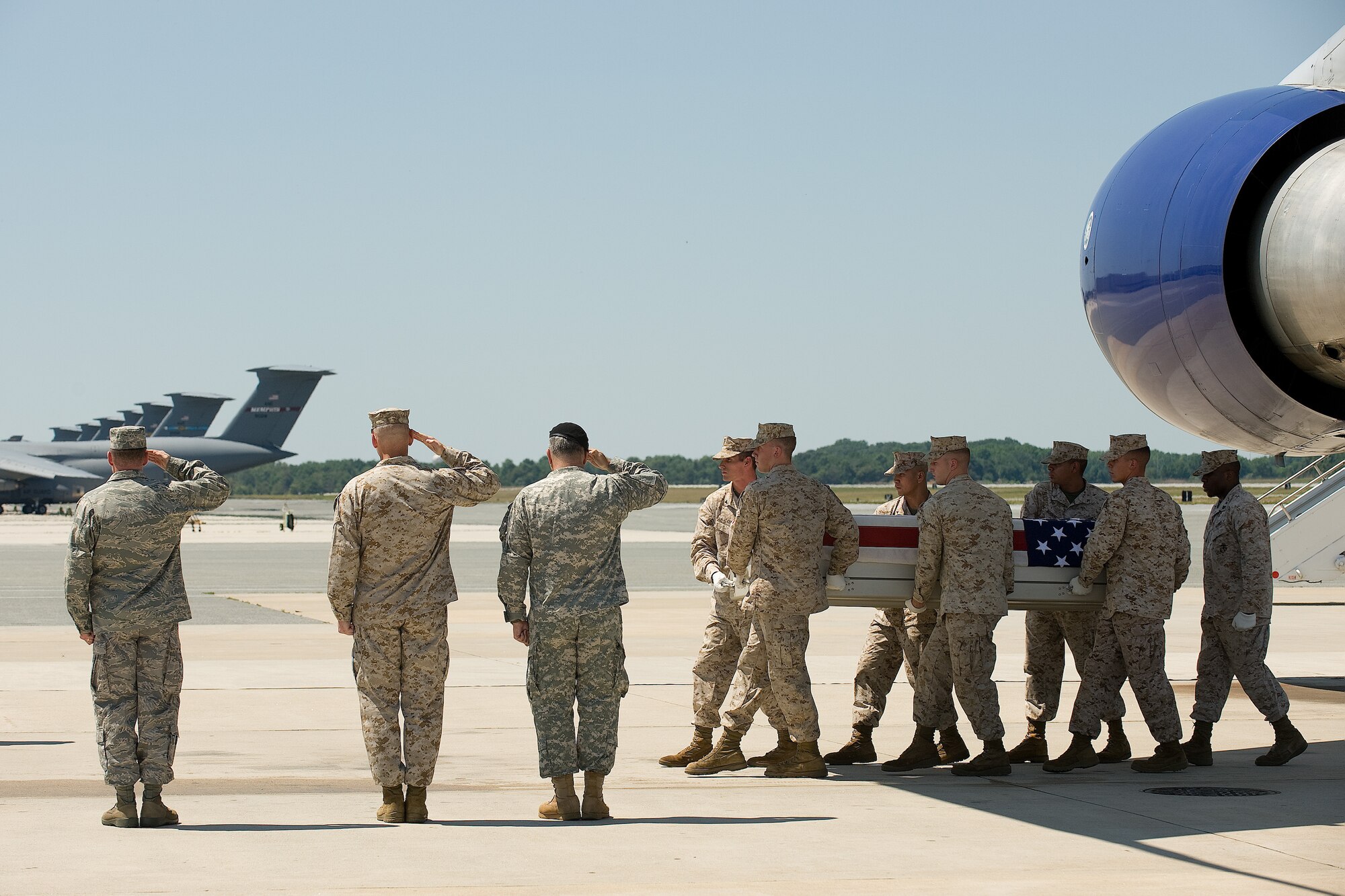 11 July 2010  USAF Photo by Jason Minto.  A U.S. Marine Corps carry team transfers the remains of Marine LCpl Tyler A. Roads of Burney, CA., at Dover Air Force Base, Del., July 11, 2010.  