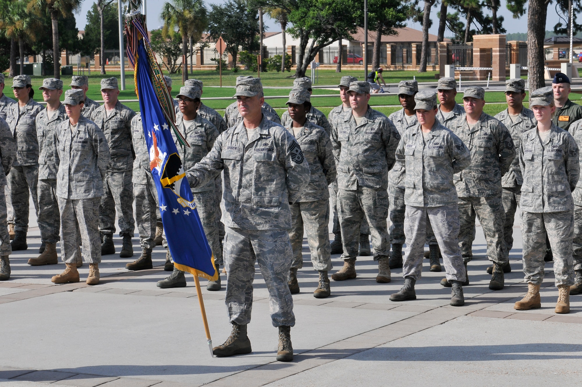 Members of the 325th Fighter Wing staff stand at parade rest in preparation for a retreat ceremony July 14. Chief Master Sgt. Jackie Green, 325th FW command chief, serves as the guidon. Retreat ceremonies will be held each month and be rotated among the squadrons. (U.S. Air Force photo/Lisa Norman) 