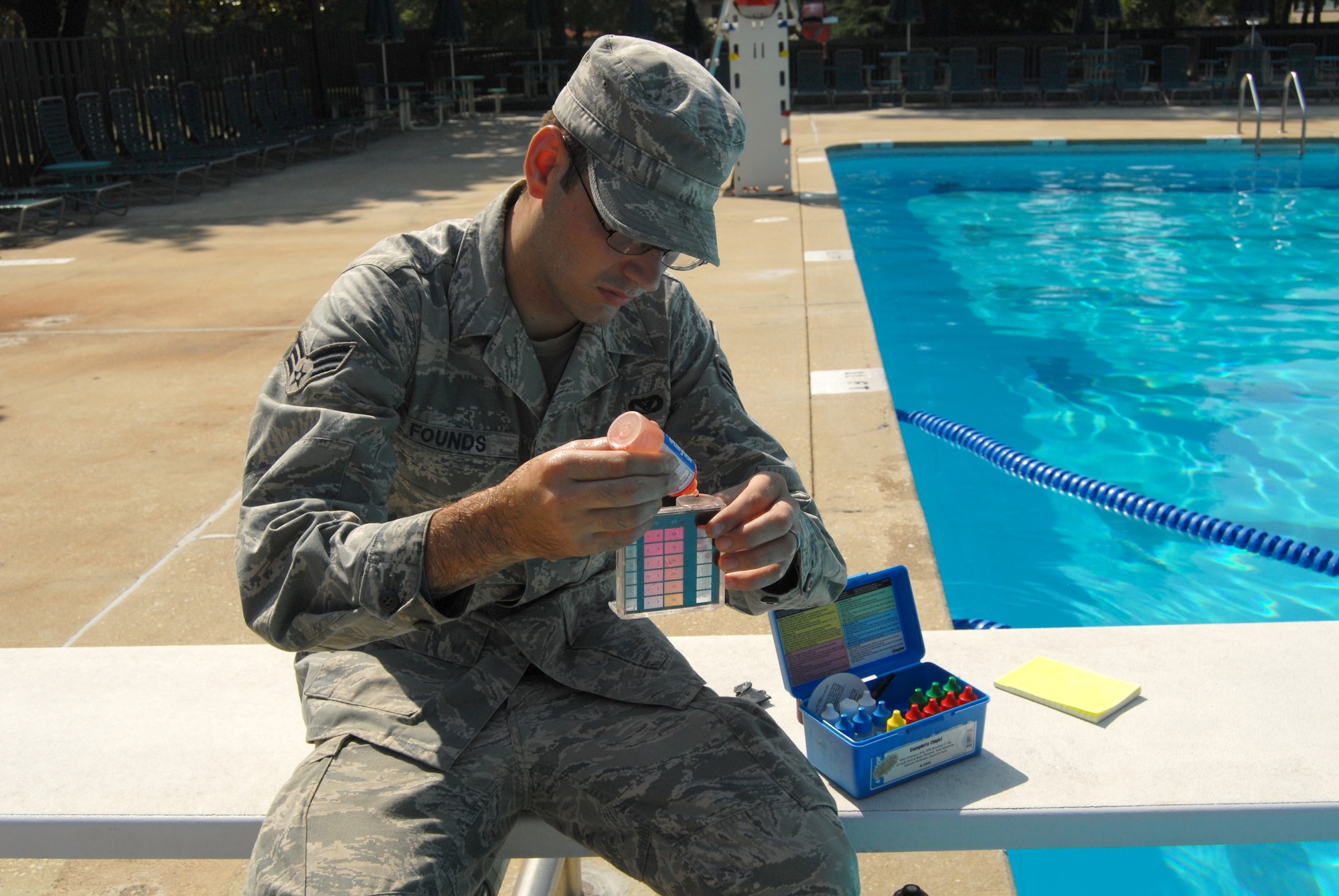 Senior Airman James Founds, 43rd Civil Engineer Squadron plumber, checks the PH balance and chlorine levels at the Pope Pool on July 15. The plumbers are responsible for maintaining water delivery systems for every facility on Pope. (U.S. Air Force photo/Senior Airman Kris Levasseur)
