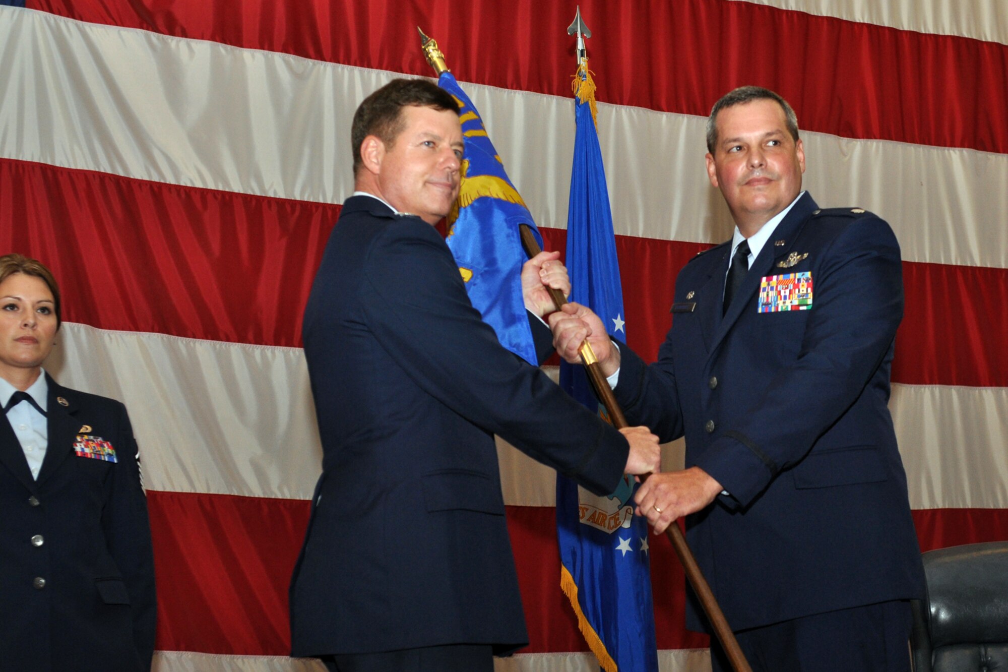 Col. Keith D. Schultz, commander, 917th Operations Group, passes the 343rd Bomb Squadron guidon to Lt. Col. Jeffrey Stogsdill during the reactivation ceremony for the historic squadron at Hoban Hall at Barksdale Air Force Base, La., July 11, 2010. The highly decorated 343rd BS had five Medals of Honor awarded to its flyers for the World War II raid on refineries at Ploesti, Romania, the most ever awarded for one action. (U.S. Air Force photo/Senior Airman Crystal Jordan) 