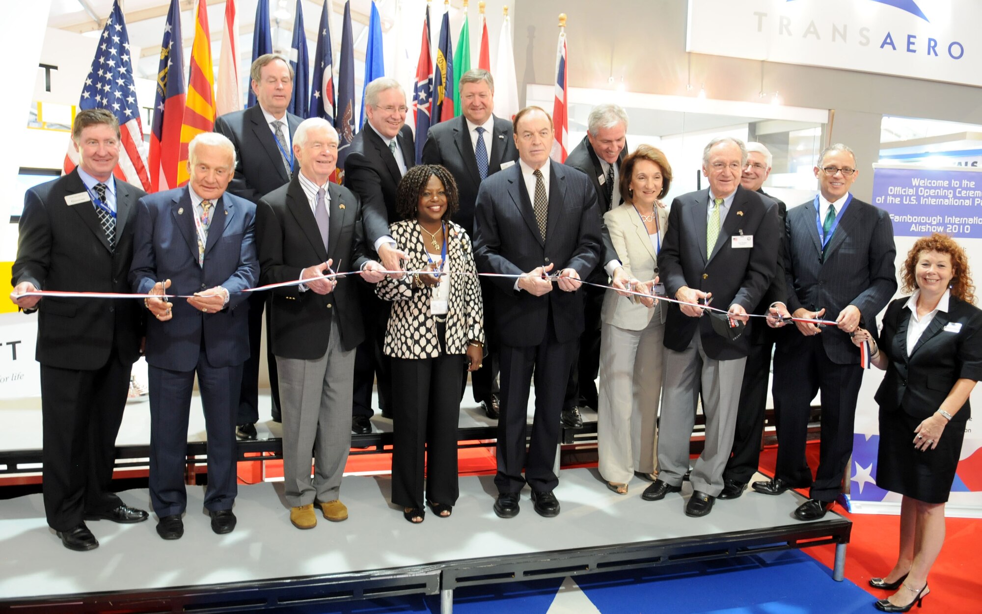 FARNBOROUGH, United Kingdom -- U.S. Secretary of the Air Force Michael B. Donley and other distinguished visitors cut the ribbon at the official grand opening ceremony at the Farnborough International Air Show July 19. Approximately 70 aircrew and support personnel from bases in Europe and the United States participated in the air show. This iconic global aviation event allows exhibitors to showcase the newest aerospace equipment and technology. The weeklong event is open to traders during the week and to the public Saturday and Sunday. (U.S. Air Force photo/ Staff Sgt. Jerry Fleshman)