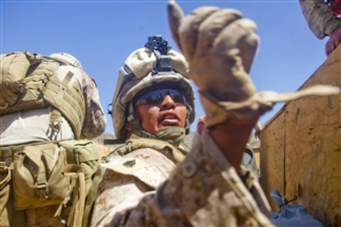 U.S. Marine Corps Sgt. D.B. Castillo, with India Company, 3rd Battalion, 5th Marine Regiment, instructs his Marines to continue fire suppression fire at Range 410 at Marine Corps Air Ground Combat Center, Twentynine Palms, Calif., during training exercise Enhanced Mojave Viper on July 14, 2010.  Enhanced Mojave Viper is a combined arms exercise that prepares Marines for deployment to Afghanistan.  