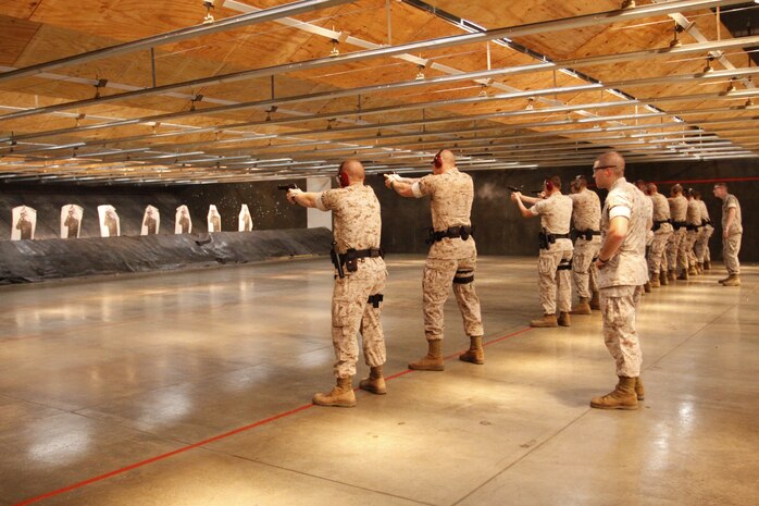 Military Police with the Provost Marshal’s Office conduct quarterly live-fire training at the Indoor Small Arms Range here July 20. Marines practiced firing the 9 mm Beretta pistol and the Benelli M1014 shotgun, weapons commonly carried by military police in the Marine Corps.