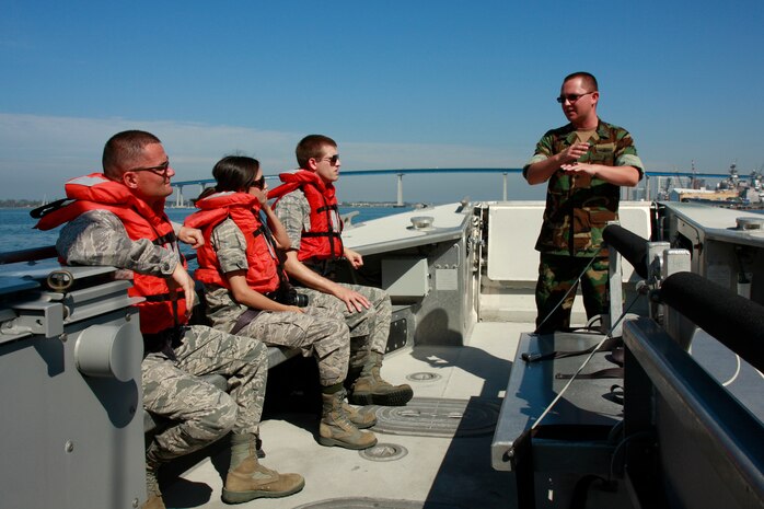 Navy Lt. Douglas Ivey, a surface warfare officer from Assault Craft Unit One, Naval Amphibious Base Coronado Island, briefs members of the Nellis Company Grade Officers' Council on amphibious landing operations while aboard a Maritime Prepositioning Force Utility Landing Craft. The Nellis officers visited Navy units on Coronado Island, Calif., as part of an officer exchange intended to broaden their joint perspectives and allow them to experience their sister services' distinctive capabilities firsthand. (U.S. Air Force photo by 2nd Lt. Kenneth Lustig)
