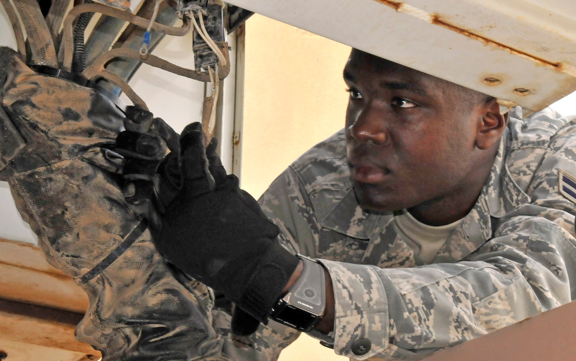 Airman 1st Class David O'Loughlin inspects a wire harness on a U30 aircraft tow vehicle July 12, 2010, at Joint Base Balad, Iraq. The U30 tow vehicle weighs approximately 100,000 pounds, making it useful for pushing and pulling heavy aircraft like the C-17 Globemaster III. Airman O'Loughlin is a 521st Air Mobility Operations Group, Det. 5 crew chief. (U.S. Air Force photo/Staff Sgt. Phillip Butterfield)