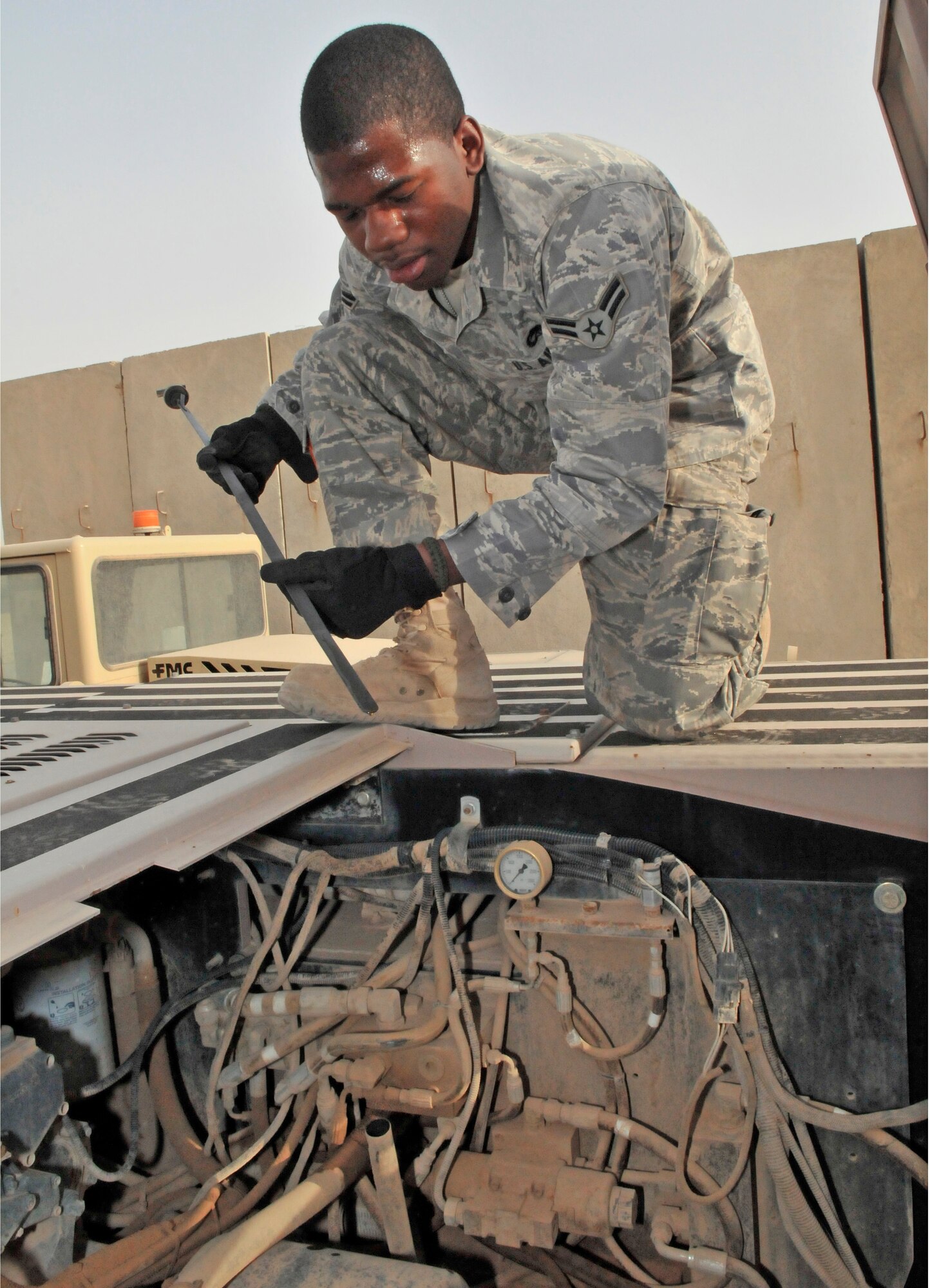 Airman 1st Class Christopher Atkins checks the oil level on a U30 aircraft tow vehicle July 12, 2010, at Joint Base Balad, Iraq. The U30 tow vehicle is used to maneuver aircraft for maintenance. Airman Atkins is a 521st Air Mobility Operations Group, Det. 5 aerospace propulsion specialist.  (U.S. Air Force photo/Staff Sgt. Phillip Butterfield) 