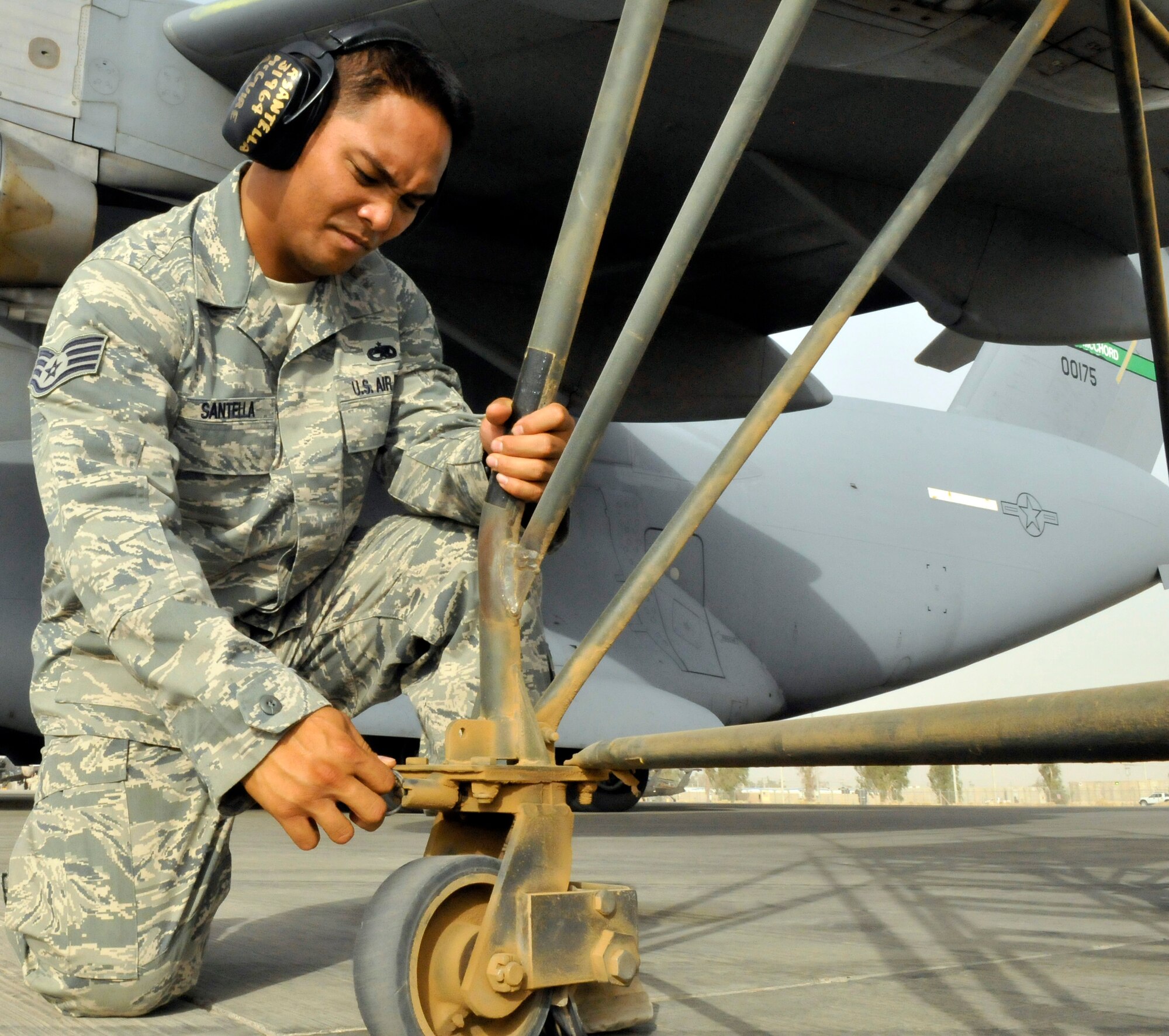 Staff Sgt. Ryan Santella locks a caster wheel of a B5 maintenance stand into place July 12, 2010, at Joint Base Balad, Iraq. The B5 Maintenance stand is the preferred stand for reaching high access panels on the C-17 Globemaster III. Sergeant Santella is a 521st Air Mobility Operations Group, Det. 5 hydraulics journeyman. (U.S. Air Force photo/Staff Sgt. Phillip Butterfield)