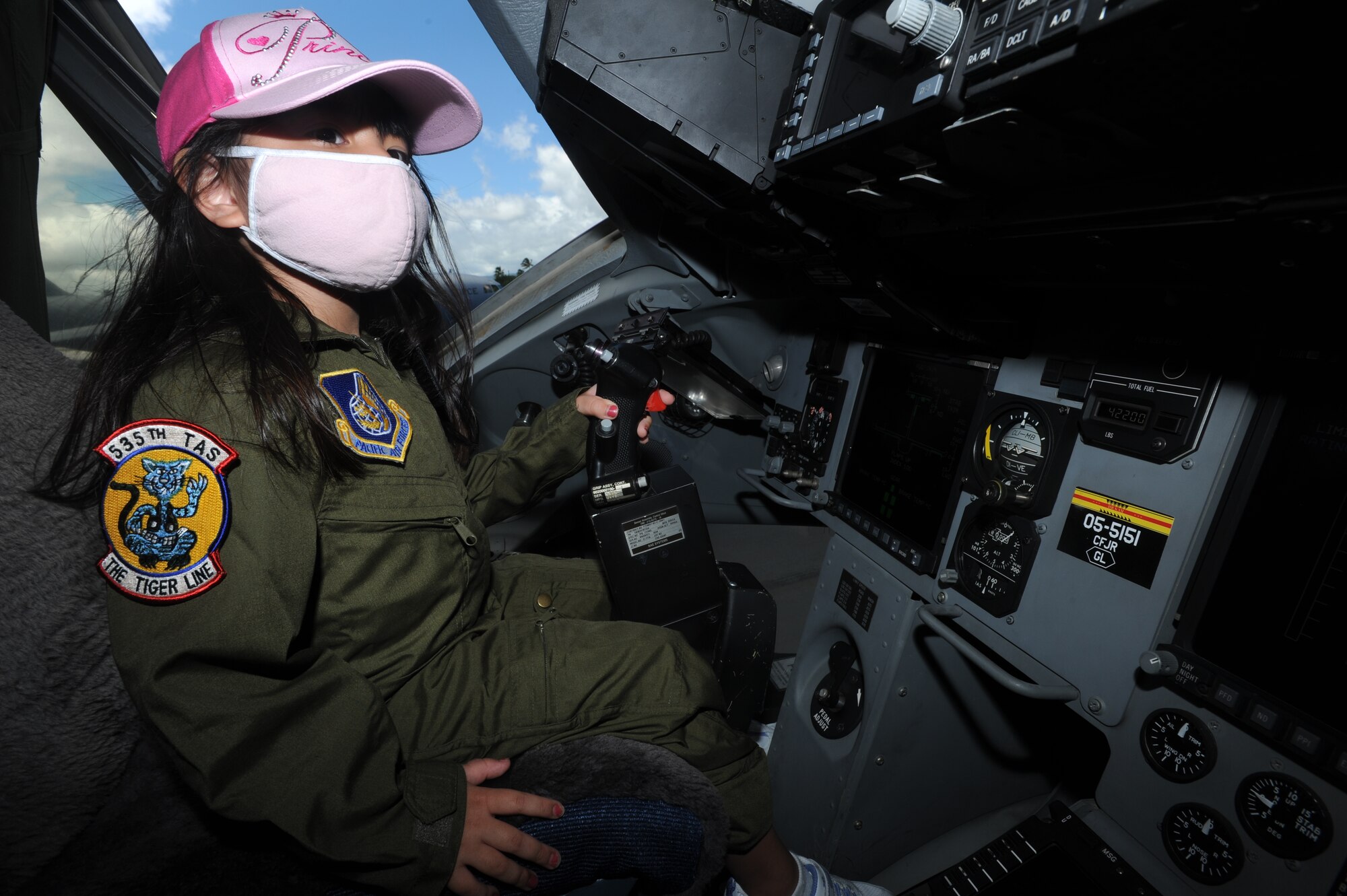 JOINT BASE PEARL HARBOR HICKAM, Hawaii - Kyra Furukawa, 5, checks out the inside of a C-17 static display during a tour as part of the Pilot for a Day Program held by the 535th Airlift Squadron here, July 16. Kyra is diagnosed with Juvenile Dermatomyositis and was chosen for the Pilot for a Day program by the Kapiolani Medical Center. (U.S. Air Force photo/Senior Airman Gustavo Gonzalez)