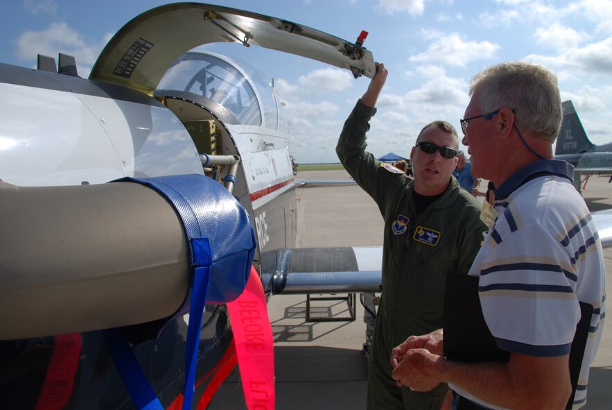 LAUGHLIN AIR FORCE BASE, Texas – Maj. James Busch, 47th Operations Group, explains specifications on a T-6 to Robert Lohr, Del Rio Elks Lodge #837, here July 19 for the Military Affairs Association Day. More than 50 business and civic leaders spent the day touring Laughlin and experienced what is required of the Airmen in the 47th Flying Training Wing to support training Air Force pilots and deploying mission ready Airmen. (U.S. Air Force photo by 2nd Lt. Lucas Jessen)