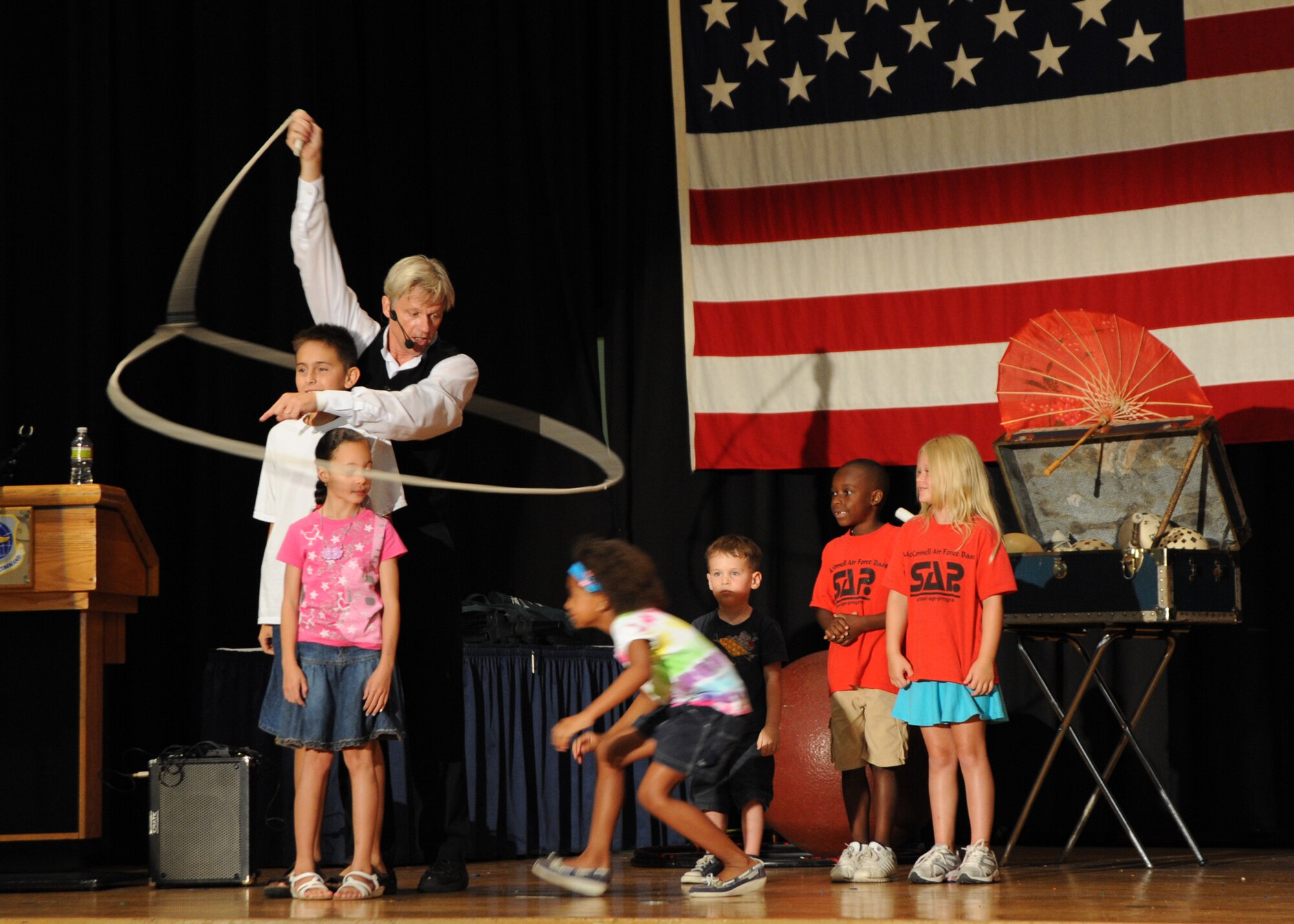 Brian Wendling, a professional juggler, performs a lasso trick with children from McConnell’s summer reading program at the Robert J. Dole Community Center ballroom, July 16, 2010, McConnell Air Force Base, Kan.  This performance marked the end of the 2010 Summer Reading Program, “Splashdown.”  Brian combines juggling, comedy and audience participation into entertainment for the family.  (U.S. Air Force photo/Airman 1st Class Andrea Salazar)