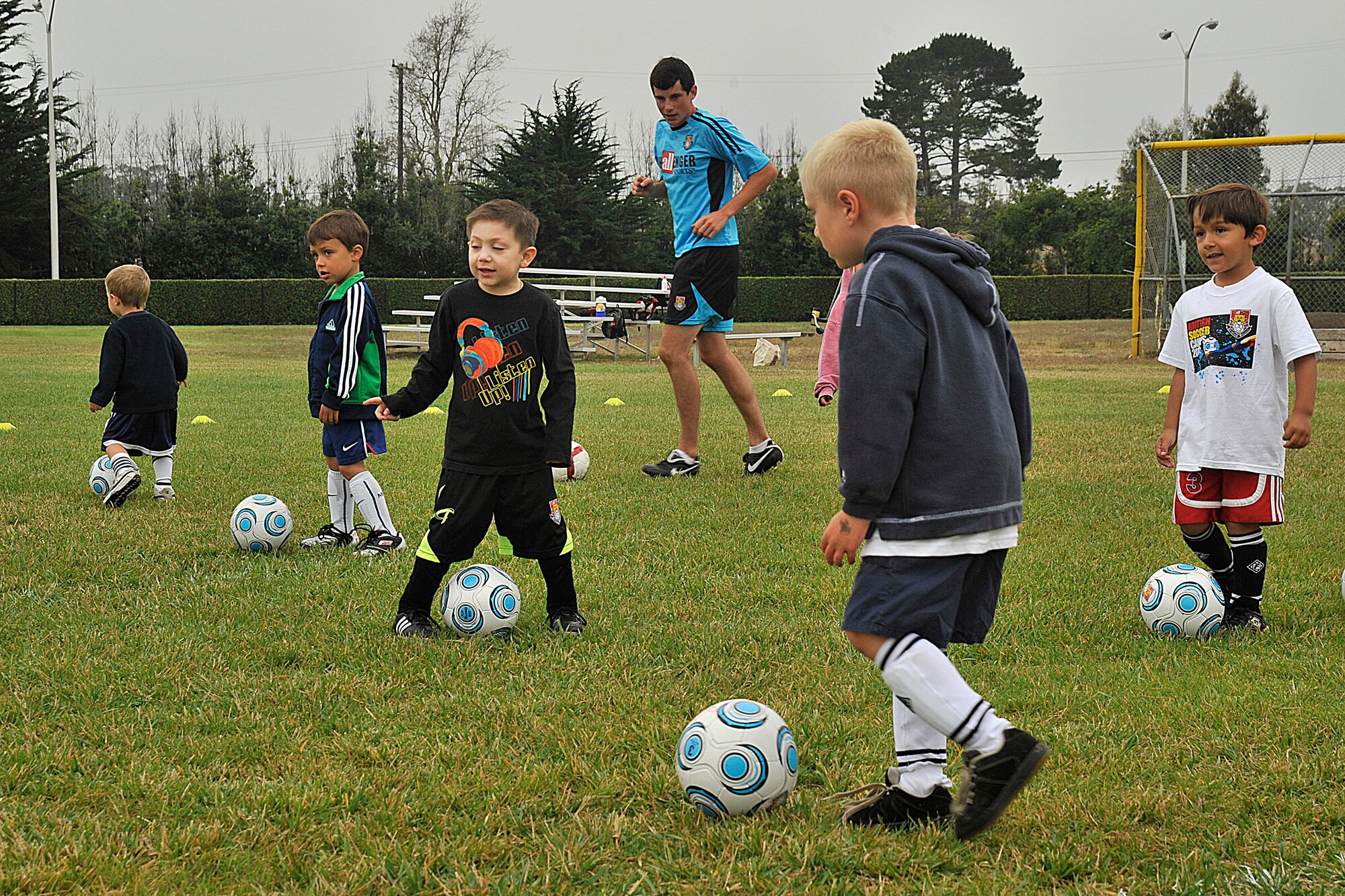 VANDNEBERG AIR FORCE BASE, Calif.--European coach David Devlin, with Challenge Sports, watches  the children dribble the soccer ball to the other side of the field. Challenge Sports is hosting their annual soccer camp at Vandenberg this week. (U.S. Air Force Photo/Senior Airman Stephanie Longoria)