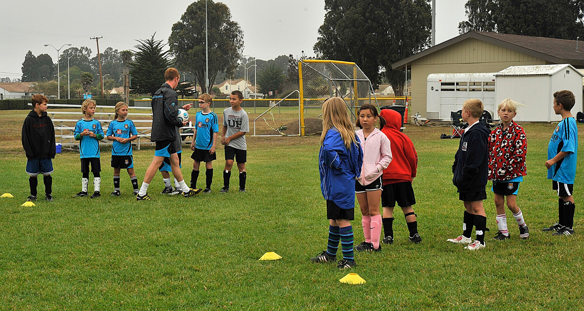 VANDNEBERG AIR FORCE BASE, Calif.--European coach Daniel Clark splits the children up into two teams, England versus U.S.A., during a soccer camp here, Tuesday July 20, 2010.  The children had to practice the drills that were taught  earlier in the day to score a point for their team. (U.S. Air Force Photo/Senior Airman Stephanie Longoria)