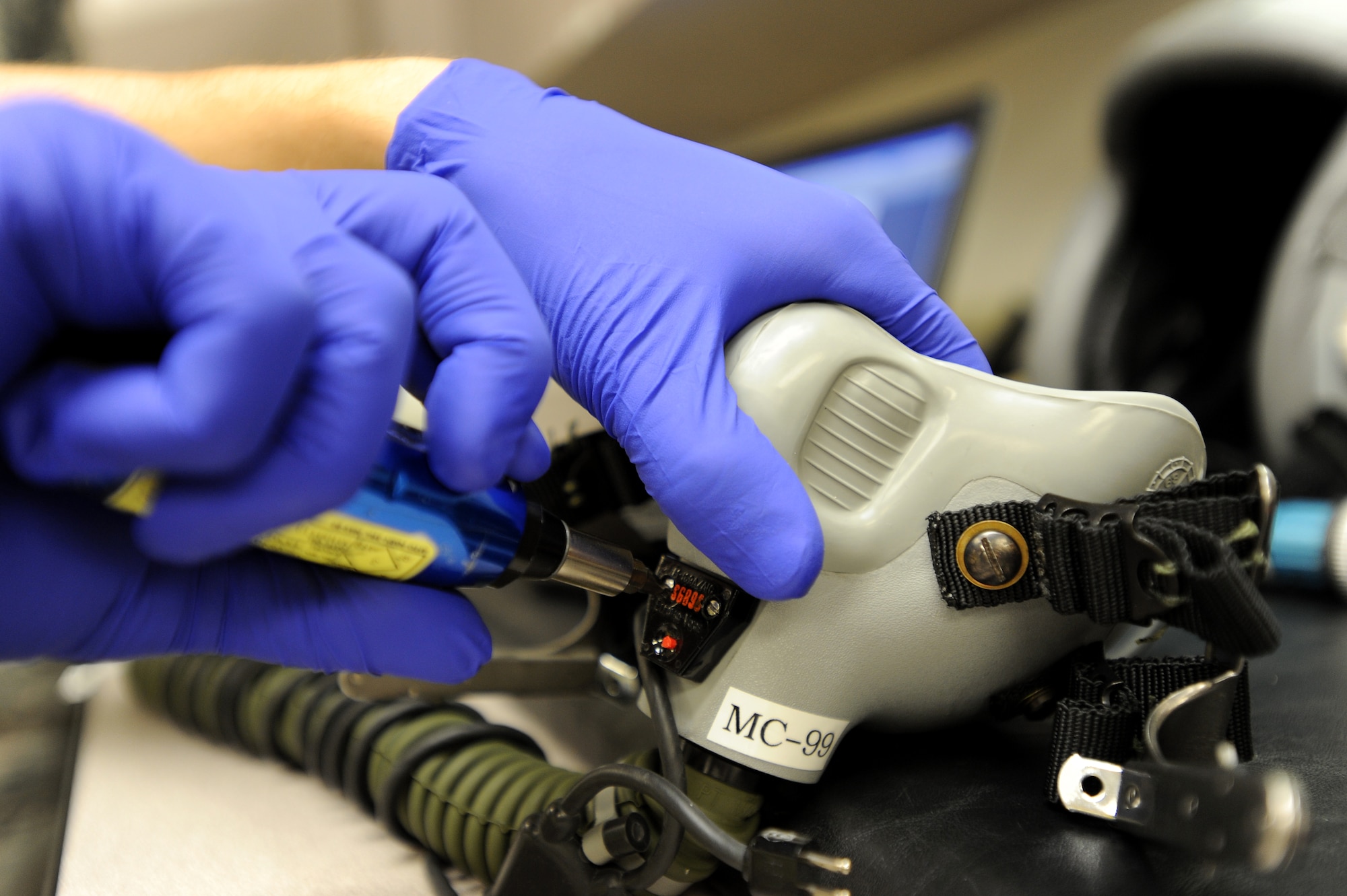 Airman 1st Class R Thompson, 22nd Operations Support Squadron aircrew flight equipment journeyman, torques a microphone back together during an inspection July 20, 2010, McConnell Air Force Base, Kan. The Airmen check for any discrepancies that might affect a pilot's breathing or communication function within the helmet, and inspect more than 15 helmets a day from a 400 plus helmet inventory. (U.S. Air Force photo/Senior Airman Courtney Witt)

