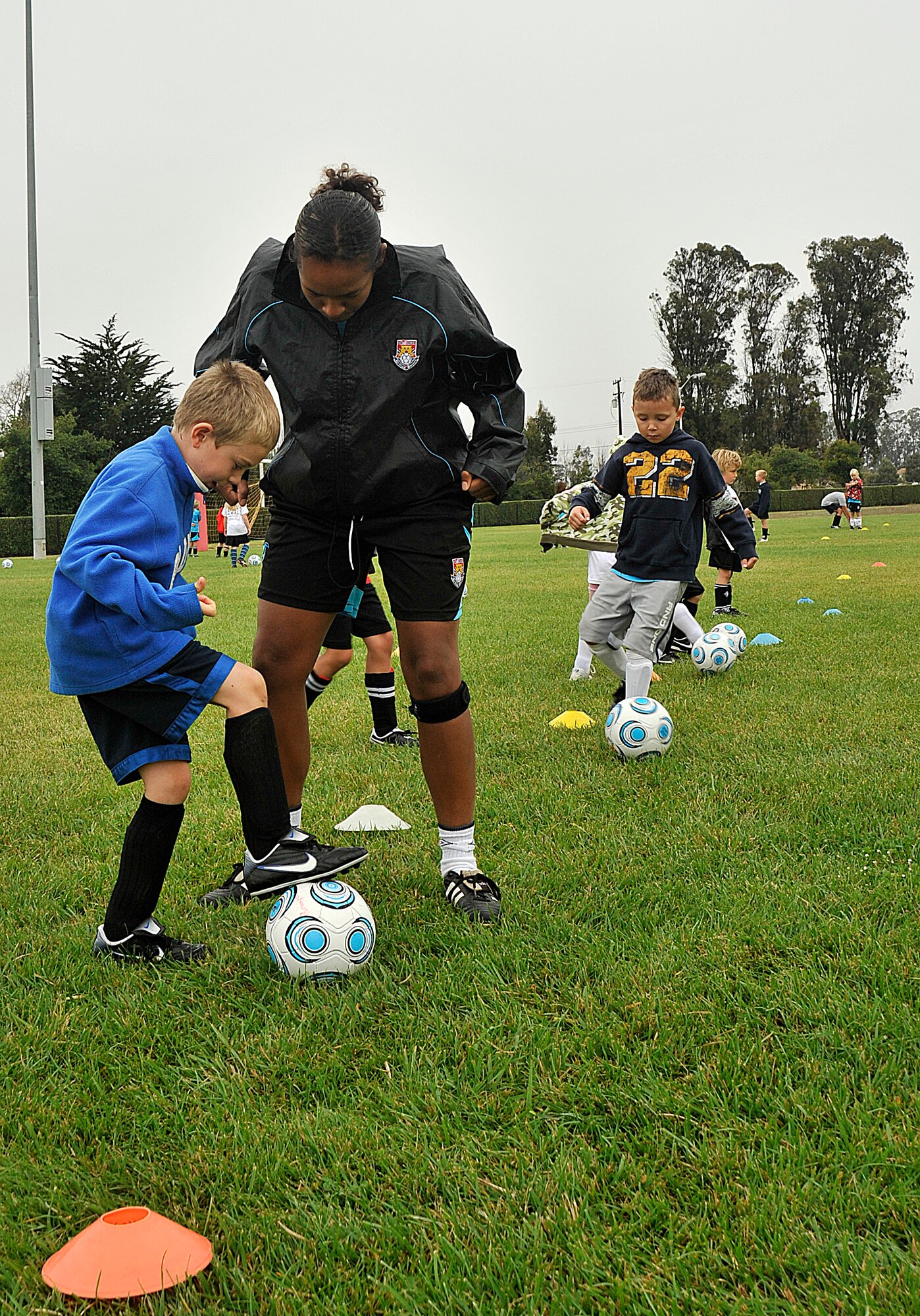 VANDNEBERG AIR FORCE BASE, Calif.-- European soccer coach Chantelle Miller,  with Challenge Sports, teaches William Fernengel, son of Capt. Christopher Fernengel, of the 14th Air Force, how to stop the ball here, Tuesday, July 20, 2010. Challenge Sports is hosting their annual soccer camp at Vandenberg this week. (U.S. Air Force Photo/Senior Airman Stephanie Longoria)