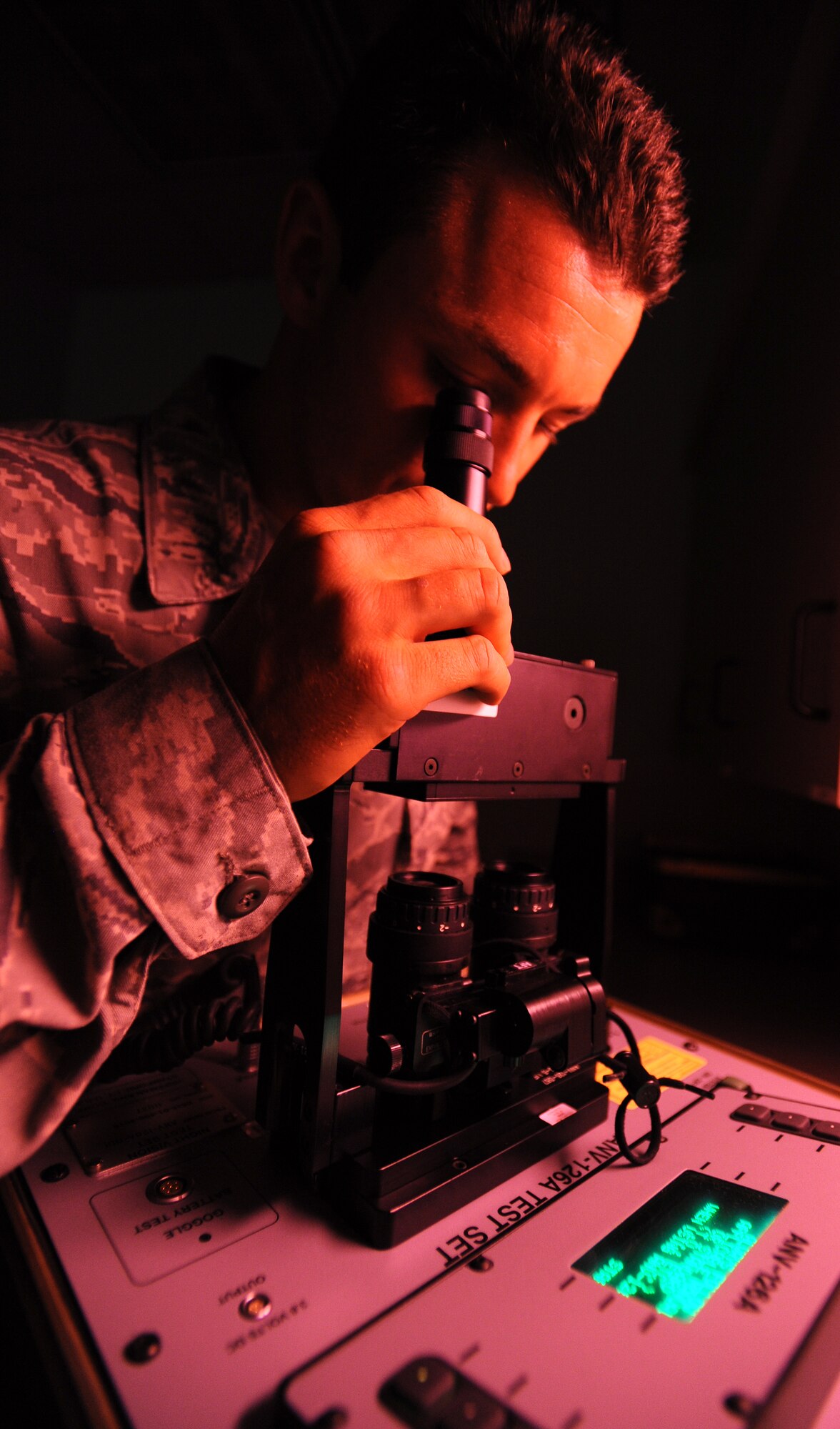 Senior Airman Jeff Short, 22nd Operations Support Squadron aircrew flight equipment journeyman, inspects a set of night vision goggles using the ANV-126A July 20, 2010, McConnell Air Force Base, Kan. The ANV-126A monitors and tests the performance and quality of the night vision by determining if there are any defects including lines or shading in the lens. McConnell inspects more than 20 night vision helmets a month every 180 days per set. (U.S. Air Force photo/Senior Airman Courtney Witt)