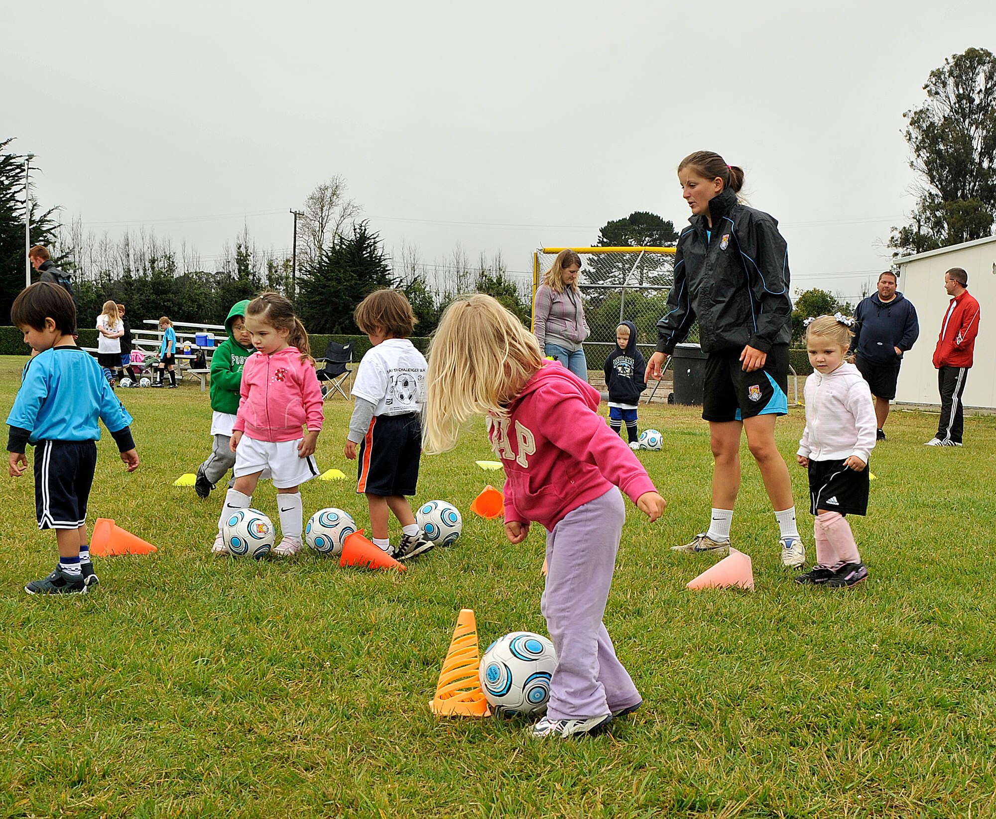VANDNEBERG AIR FORCE BASE, Calif.-- Children play Alien Attack during a soccer camp here Tuesday, July 20, 2010. The objective of the game is to try knocking the cones down by kicking the soccer ball using the side of their foot. European coaches with Challenge Sports incorporate games such as Alien Attack with basic soccer skills to keep children interested in learning to play the game of soccer. (U.S. Air Force Photo/Senior Airman Stephanie Longoria)