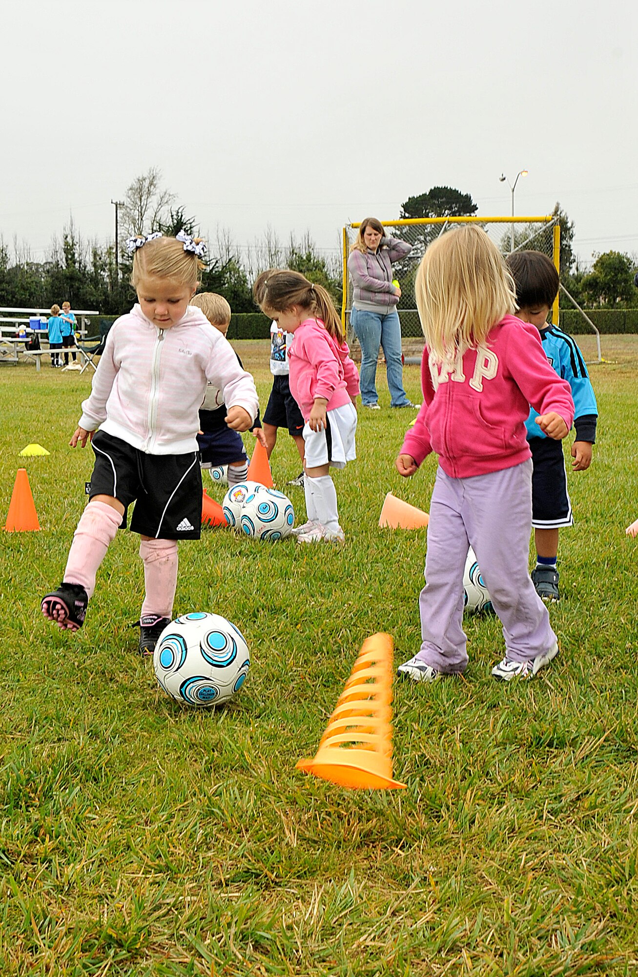 VANDNEBERG AIR FORCE BASE, Calif.-- Children try to take down aliens (orange cones) by kicking their "laser" soccer ball during soccer camp here, Tuesday, July 20, 2010. European coaches with Challenge Sports incorporate games such as Alien Attack with basic soccer skills to keep children, ages three to four, interested in learning to play the game of soccer. (U.S. Air Force Photo/Senior Airman Stephanie Longoria)