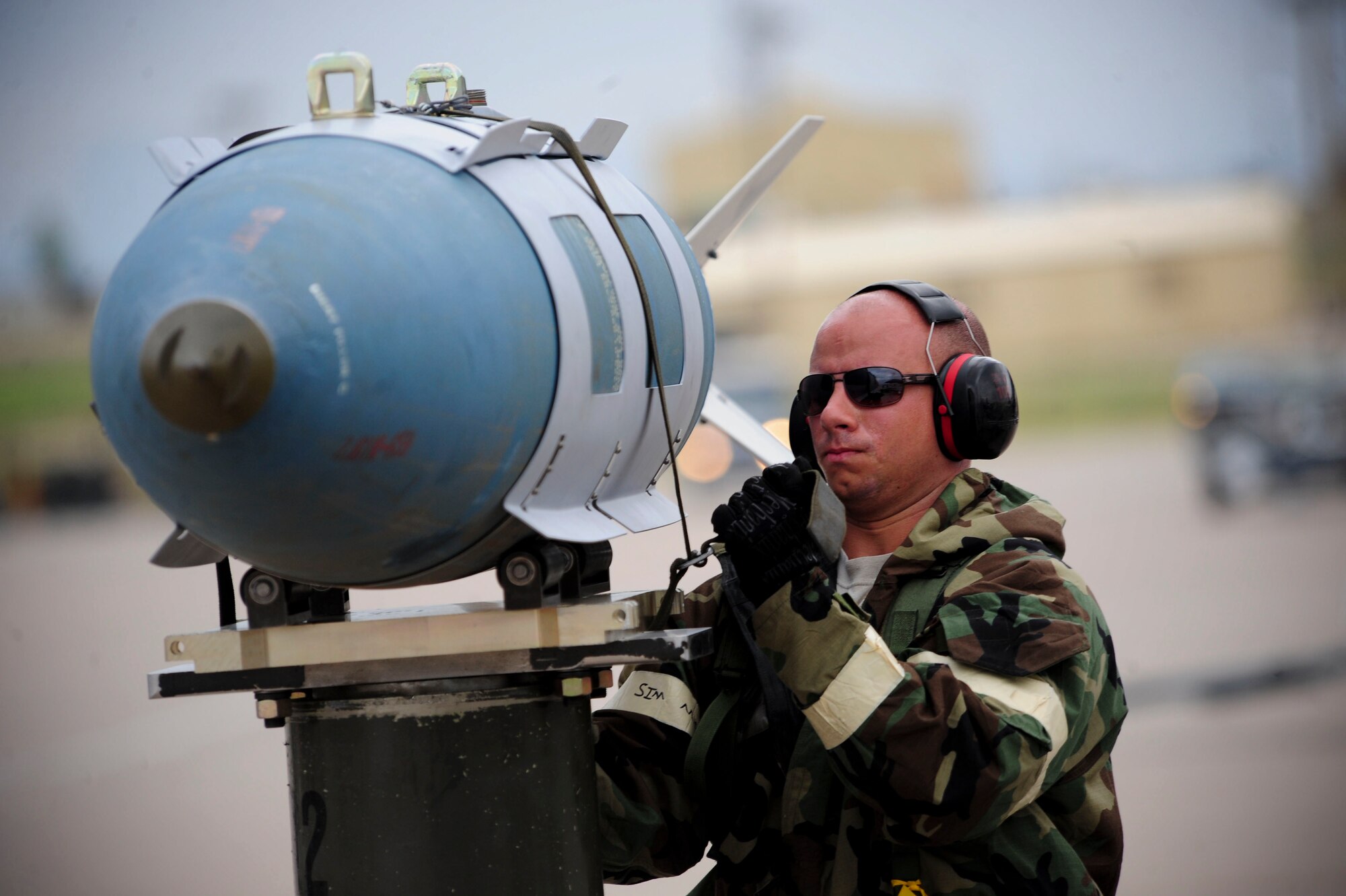 ELLSWORTH AIR FORCE BASE, S.D. – Airman 1st Class Jordan Linial, 28th Munitions Squadron weapon loader, tightens a strap onto a guided bomb unit-31 during the phase II operational readiness exercise, July 21. A B-1B Lancer can fit 24 GBU-31s, which weigh 2,000 pounds each.(U.S. Air Force photo/Airman 1st Class Corey Hook)