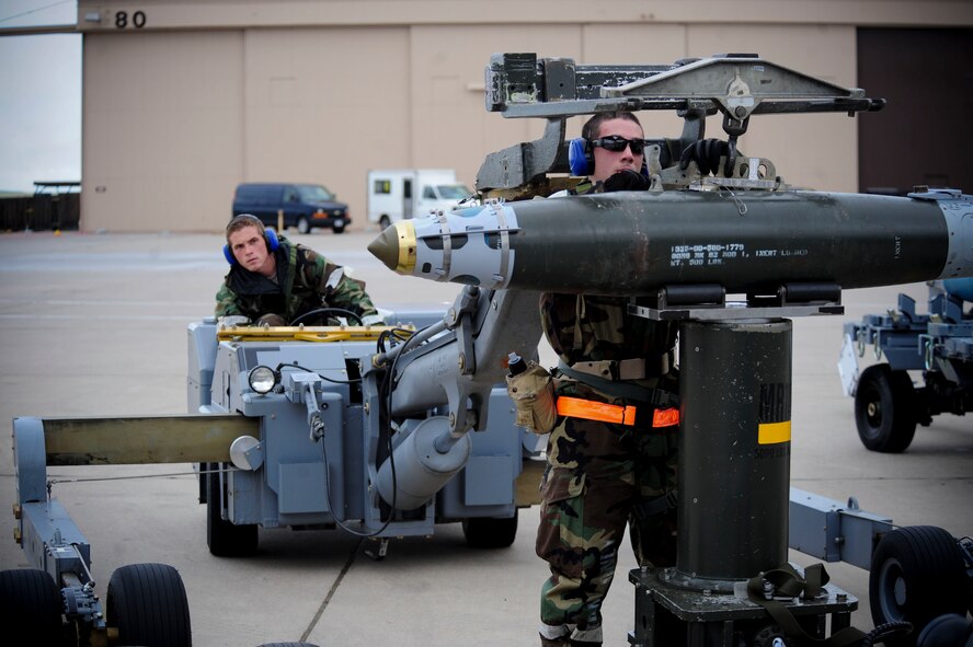 ELLSWORTH AIR FORCE BASE, S.D. – (Front) Airman 1st Class Alejandro Sanchez and Staff Sgt. Matthew Egler move a guided bomb unit-38 during the phase II operational readiness exercise, July 21. Sergeant Egler and Airman Sanchez are weapon loaders assigned to the 28th Munitions Squadron. (U.S. Air Force photo/Airman 1st Class Corey Hook)