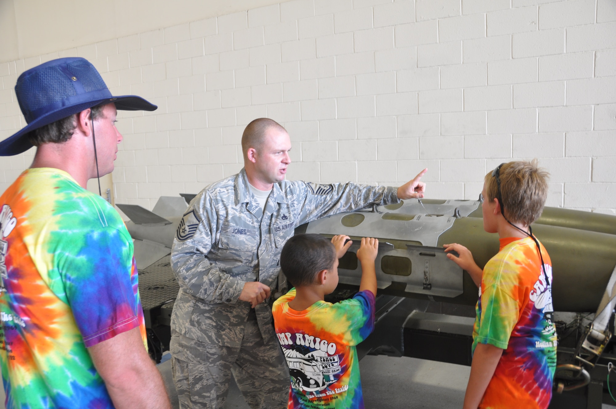Master Sgt. Jeff Jones, a F-22 loading standardization crew chief, talks with burn survivors from Camp Amigo during their tour of Tyndall July 15.  (U.S. Air Force photo/Senior Airman Veronica McMahon)