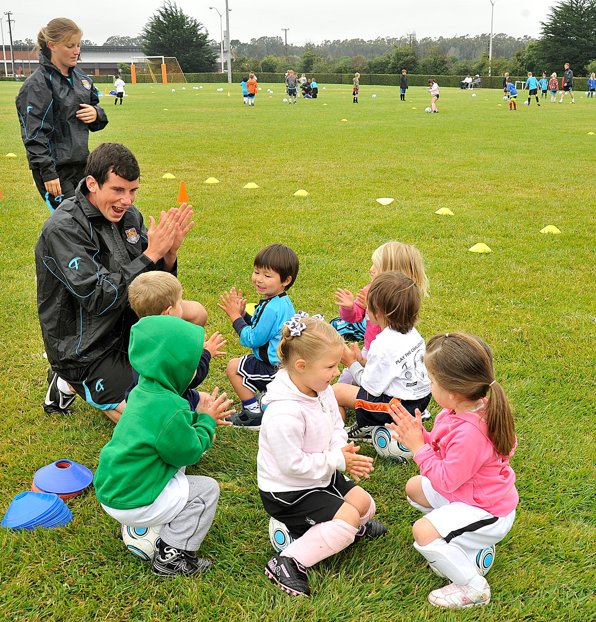 VANDNEBERG AIR FORCE BASE, Calif.--European coaches Fern Burrage and David Devlin with Challenge Sports, teach children basic soccer skills here, Tuesday, July 20, 2010.  The coaches use games such as Alien Attack and Spongebob to keep the children interested in learning the basic skills. (U.S. Air Force Photo/Senior Airman Stephanie Longoria)