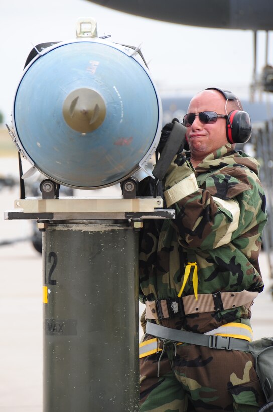 ELLSWORTH AIR FORCE BASE S.D. -- Airman 1st Class Jordan Linial, 28th Aircraft Maintenance Squadron weapons technician, straps a guided bomb unit-31 to a munitions handling unit before it's loaded onto a B-1B Lancer during a phase II operational readiness exercise, July 21. During the phase II ORE, maintenance Airmen are a vital piece of the mission in the simulated deployed environment. (U.S. Air Force photo/Airman 1st Class Anthony Sanchelli)