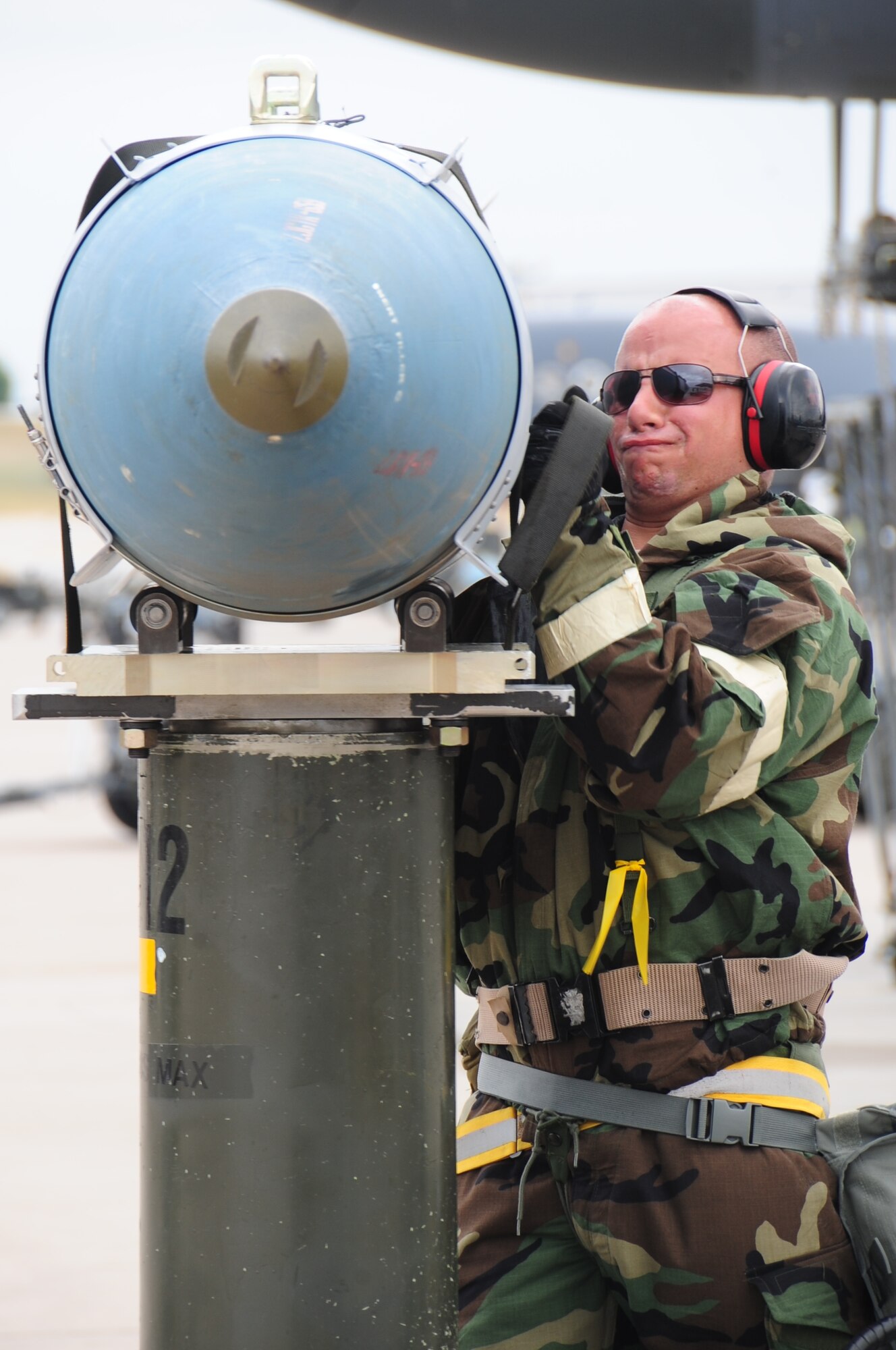 ELLSWORTH AIR FORCE BASE S.D. -- Airman 1st Class Jordan Linial, 28th Aircraft Maintenance Squadron weapons technician, straps a guided bomb unit-31 to a munitions handling unit before it's loaded onto a B-1B Lancer during a phase II operational readiness exercise, July 21. During the phase II ORE, maintenance Airmen are a vital piece of the mission in the simulated deployed environment. (U.S. Air Force photo/Airman 1st Class Anthony Sanchelli)