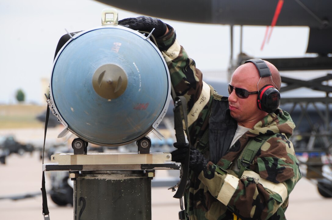 ELLSWORTH AIR FORCE BASE S.D. -- Airman 1st Class Jordan Linial, 28th Aircraft Maintenance Squadron weapons technician, straps a guided bomb unit-31 to a munitions handling unit before it's loaded onto a B-1B Lancer during a phase II operational readiness exercise, July 21.  During the phase II ORE, Airmen are tested on their ability to operate in a simulated deployed environment. (U.S. Air Force photo/Airman 1st Class Anthony Sanchelli)